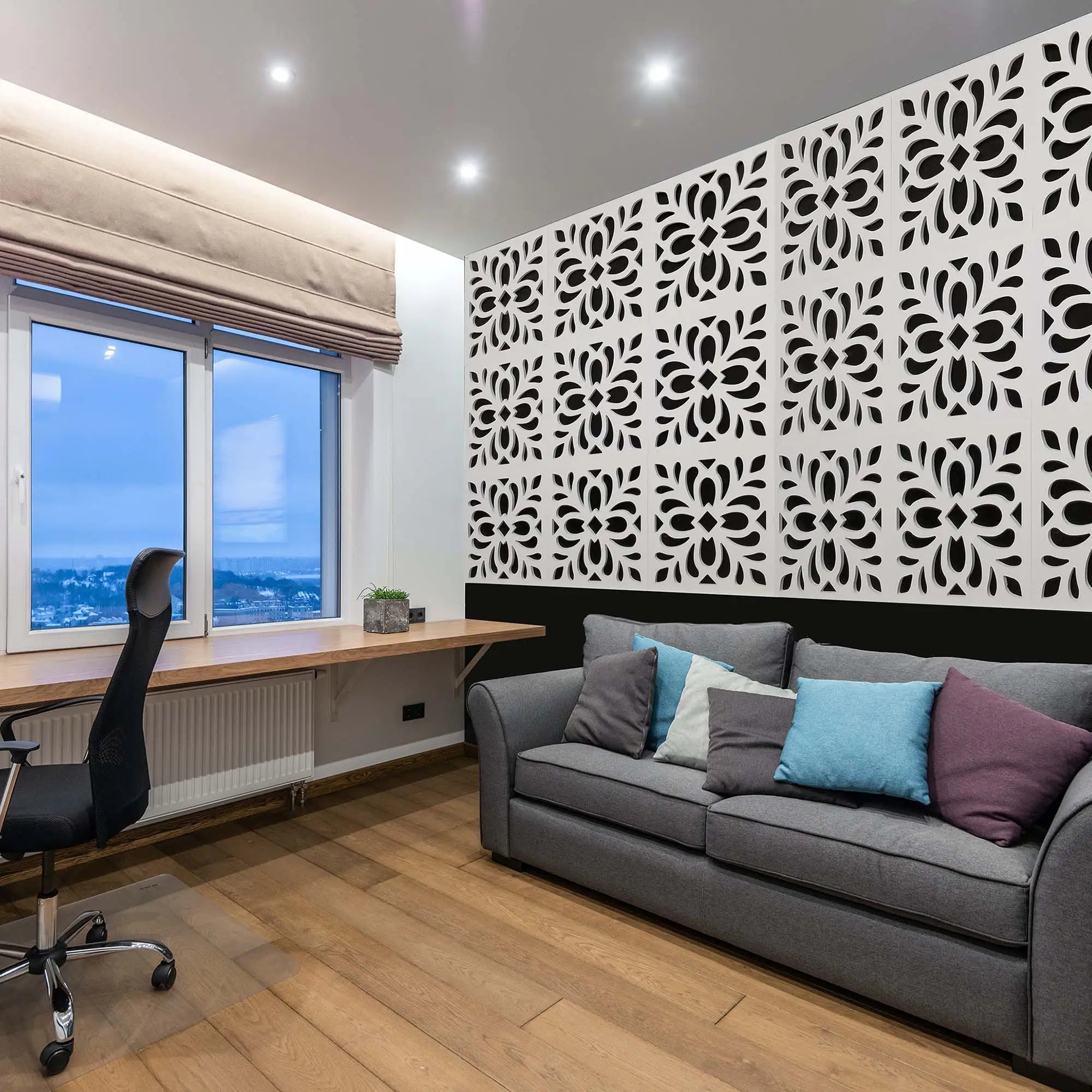 Modern living room with gray sofa, decorative wall panel, and large window.
