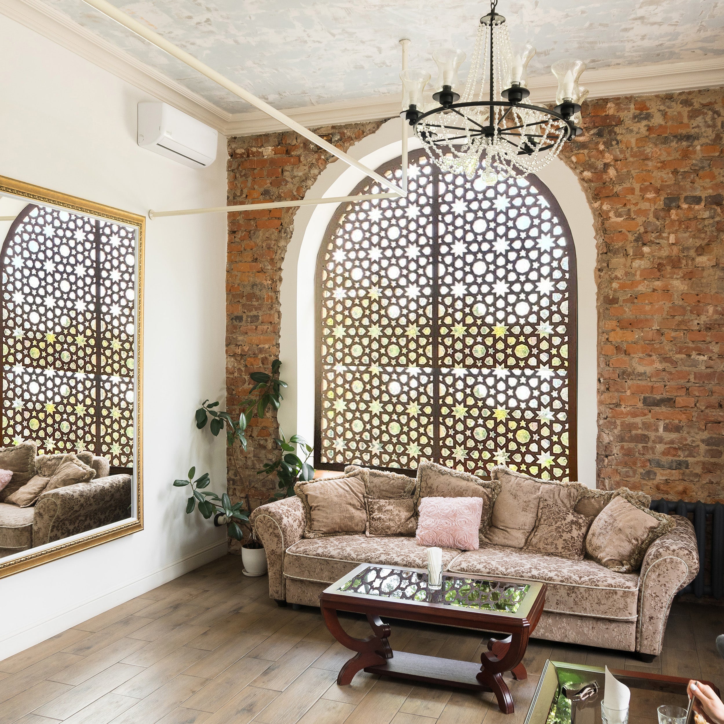 Living room with a brick wall, sofa, and decorative elements.