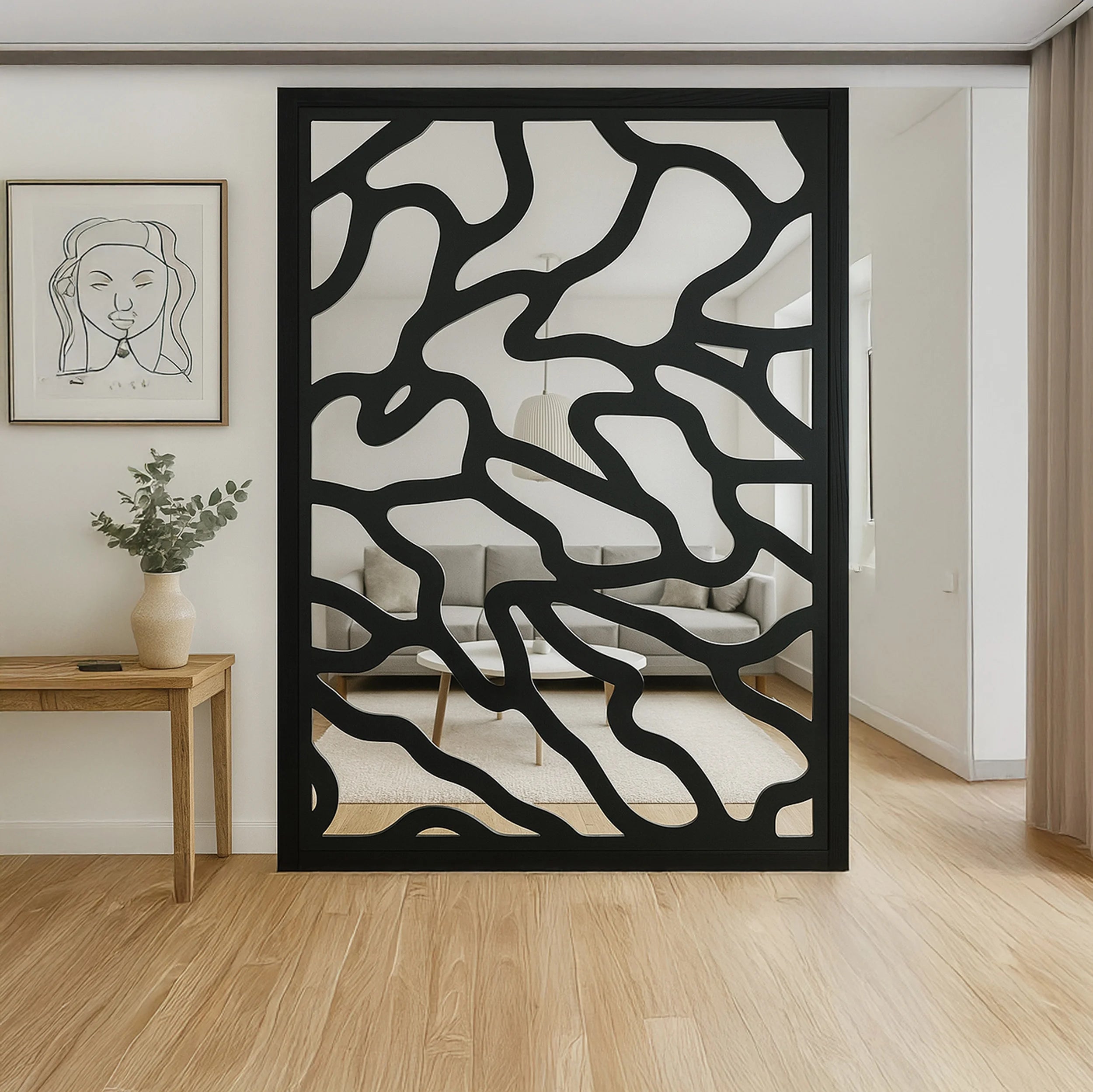 Decorative black screen with wavy pattern in a room with wooden floor and white walls.