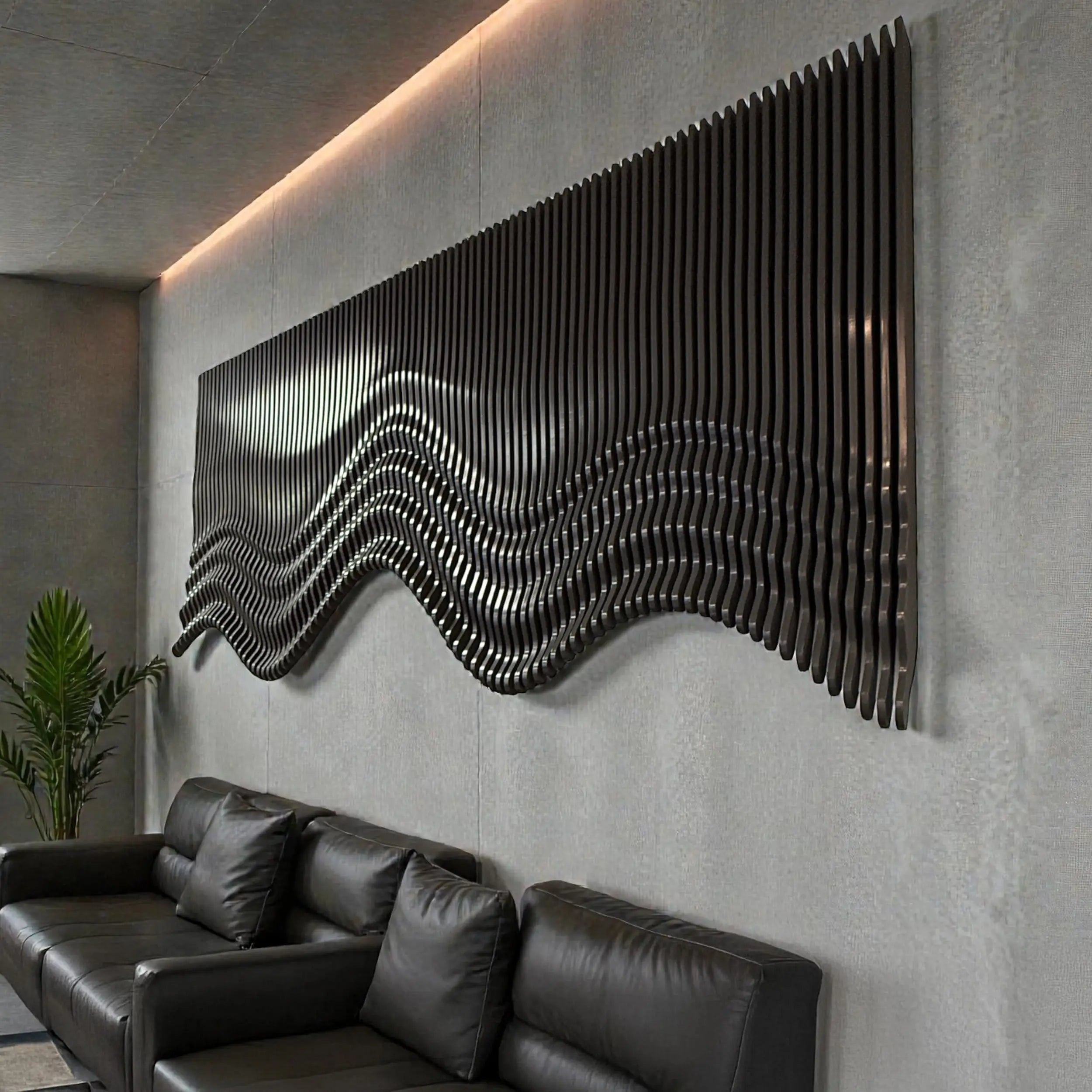 Modern living room with a black leather sofa and decorative wall art.