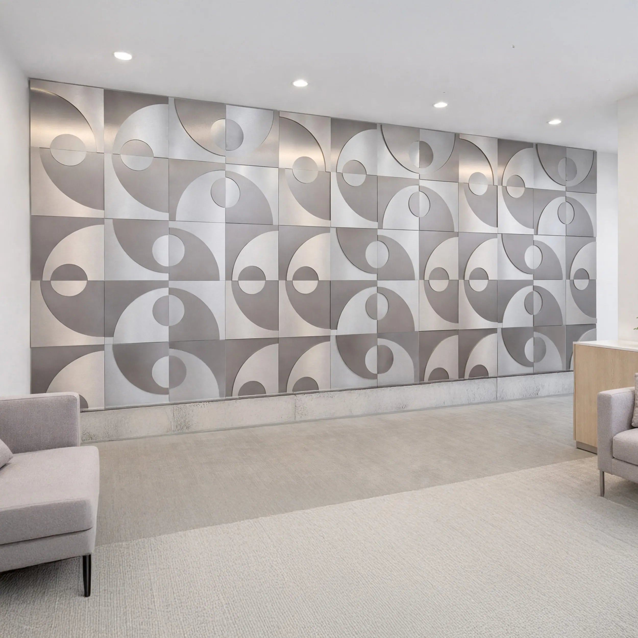 Modern interior with geometric wall paneling and gray furniture.