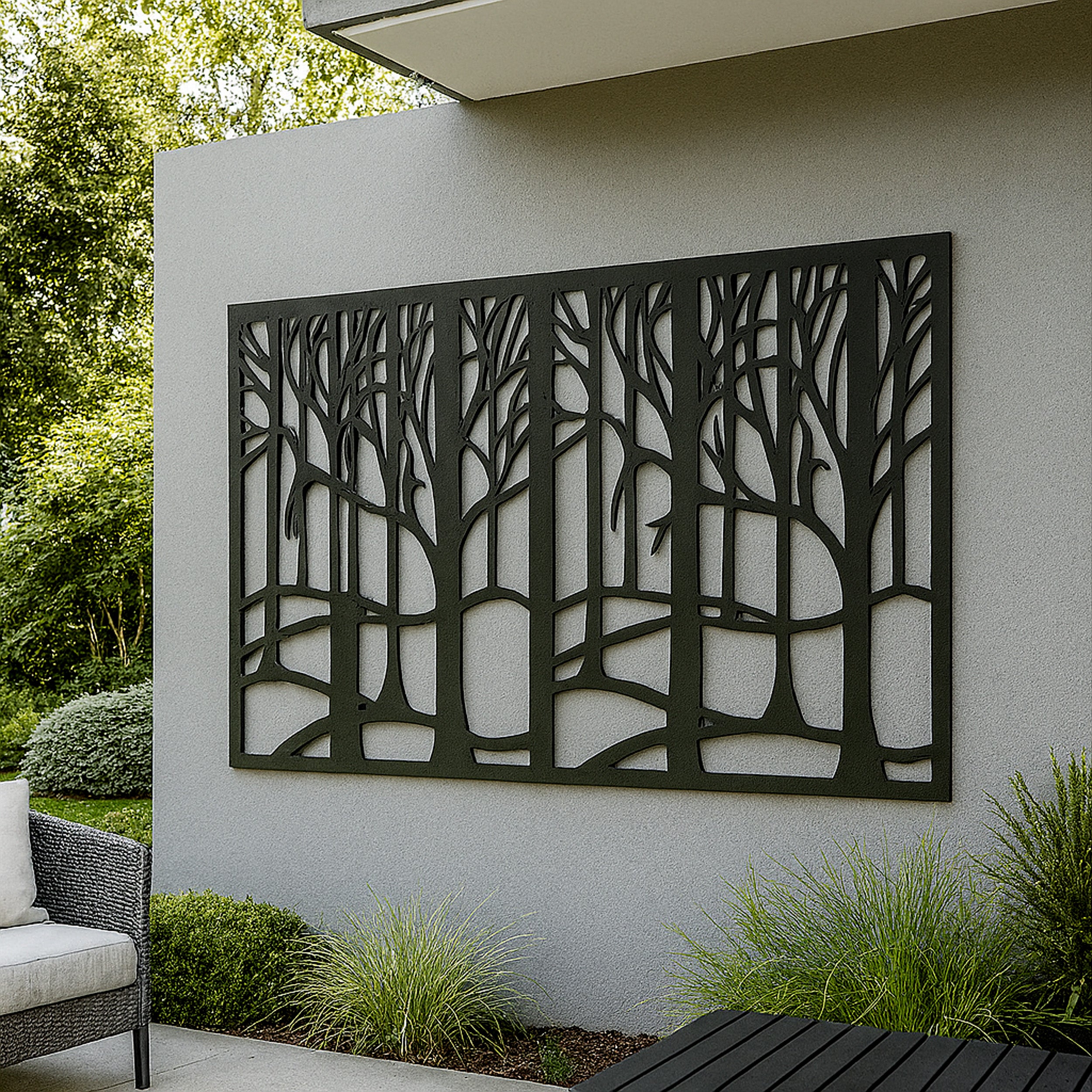 Decorative outdoor metal wall panel with tree design on a gray wall outdoors.