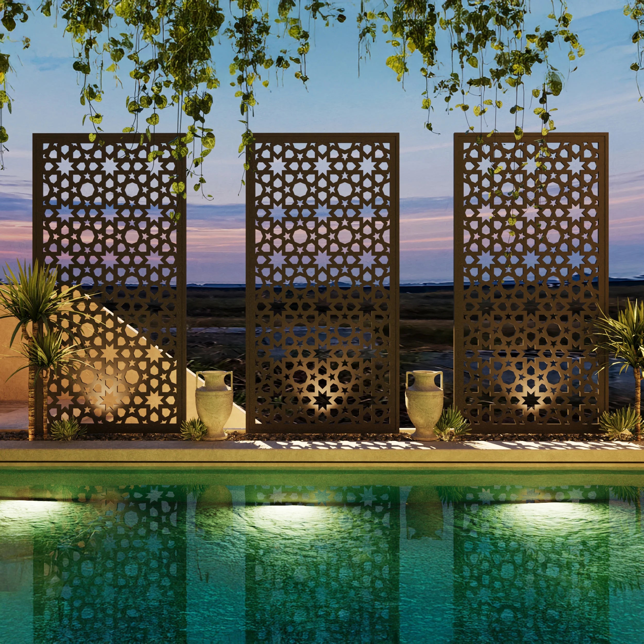 Decorative metal screens with intricate patterns by a pool at dusk.