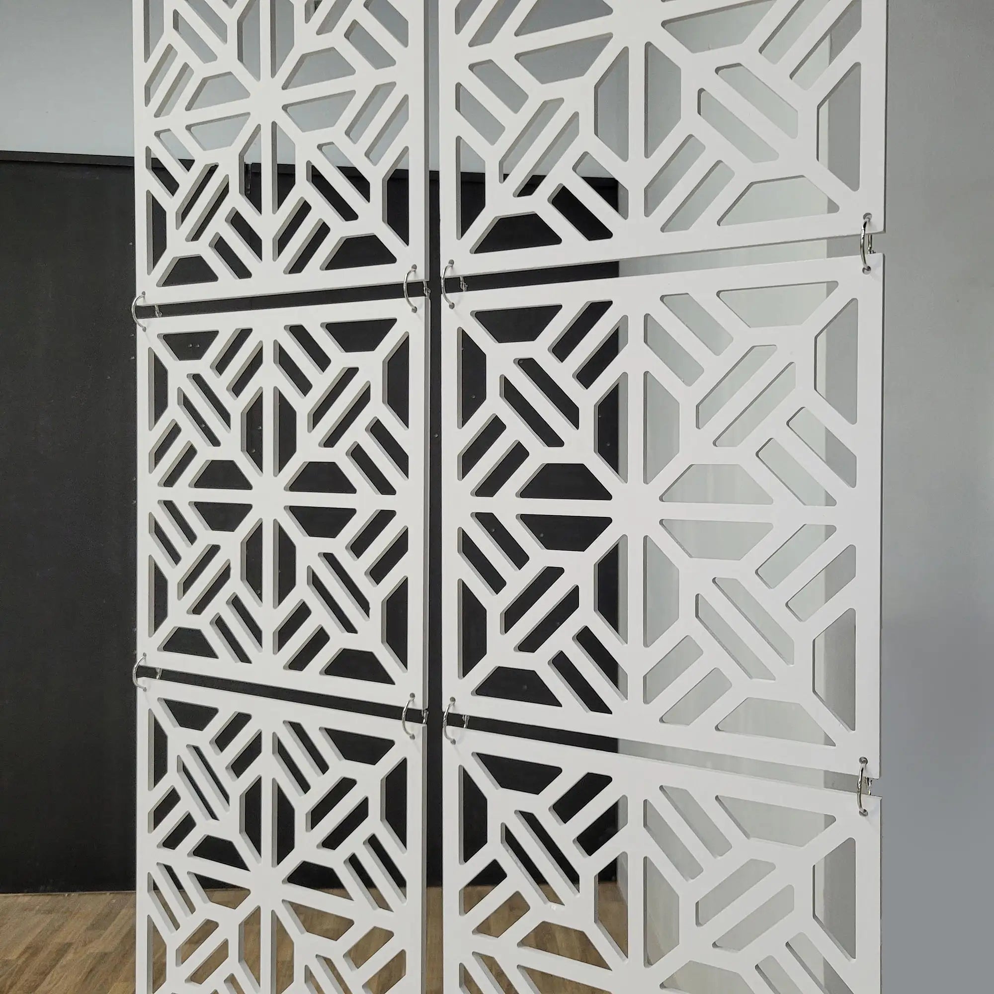 Decorative screen with geometric pattern in a room setting