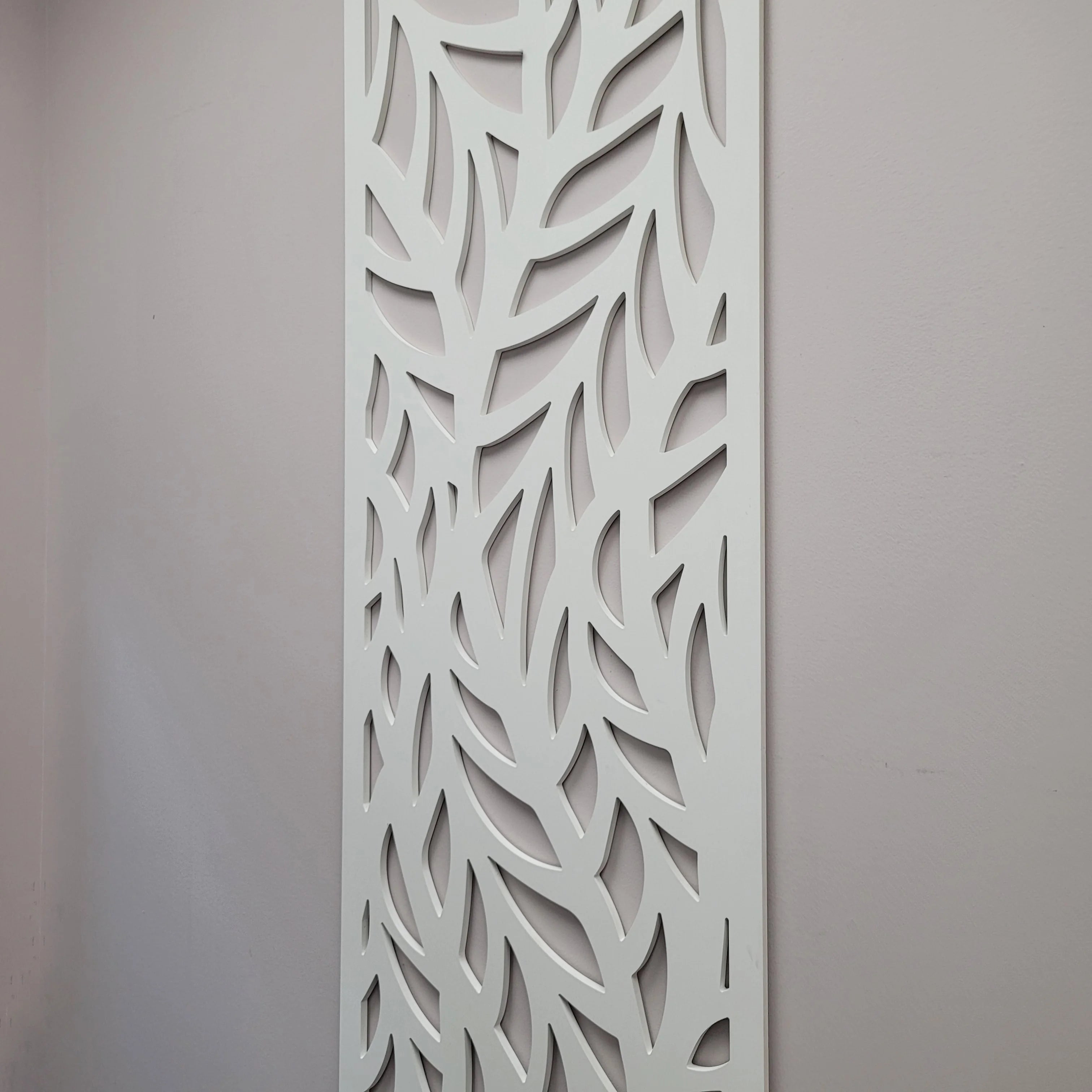 Decorative panel with cut-out leaf pattern on a plain background