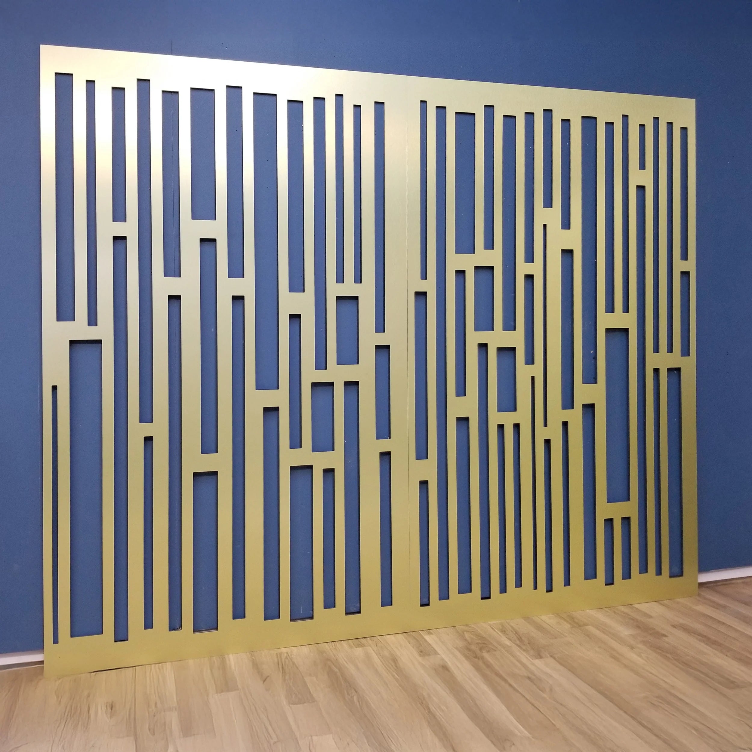 Gold decorative screen against a blue wall
