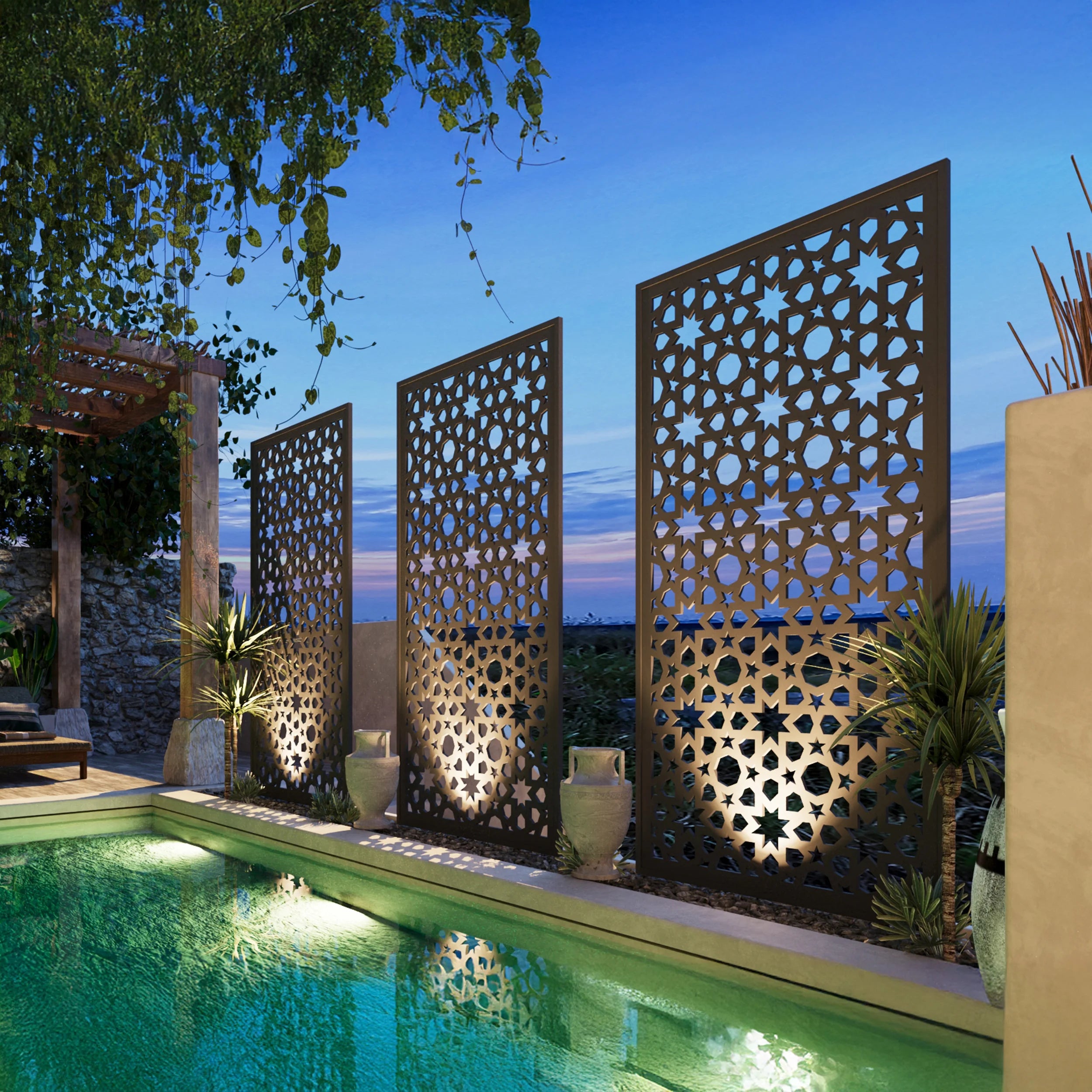 Decorative metal screens by a pool with a blue sky background