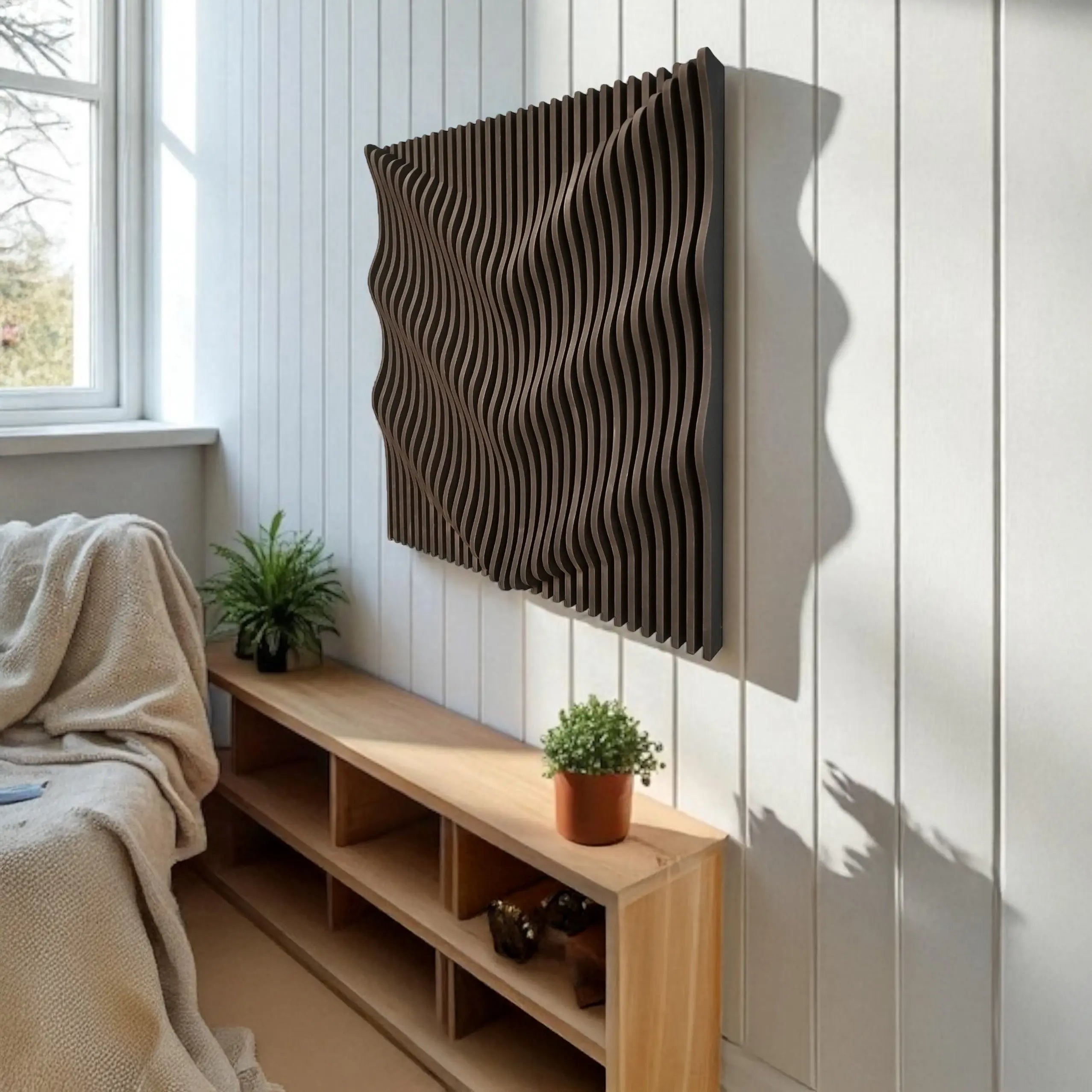 Decorative wall panel on a white paneled wall with a wooden shelf below.