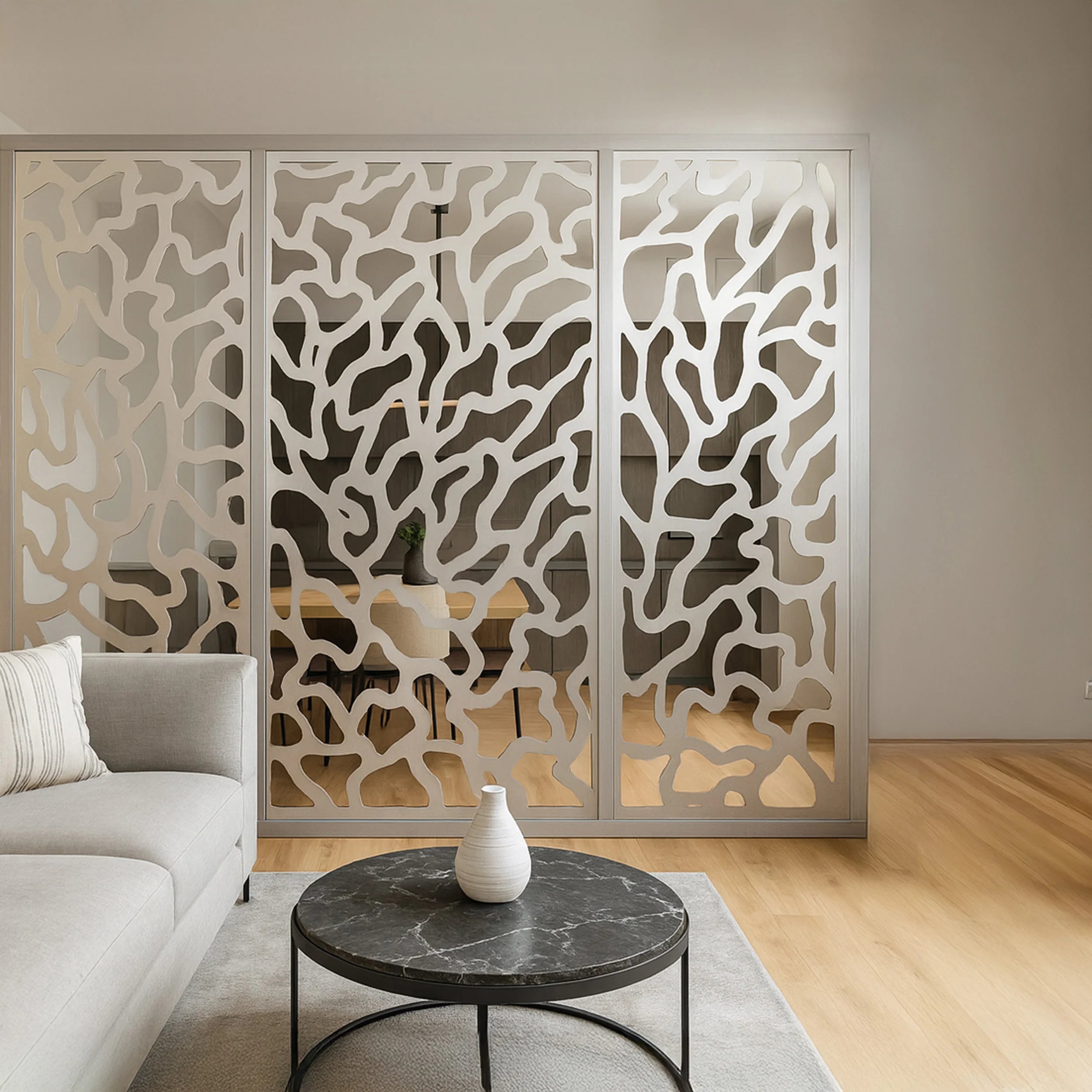 Decorative screen with intricate cut-out design in a modern living room setting.
