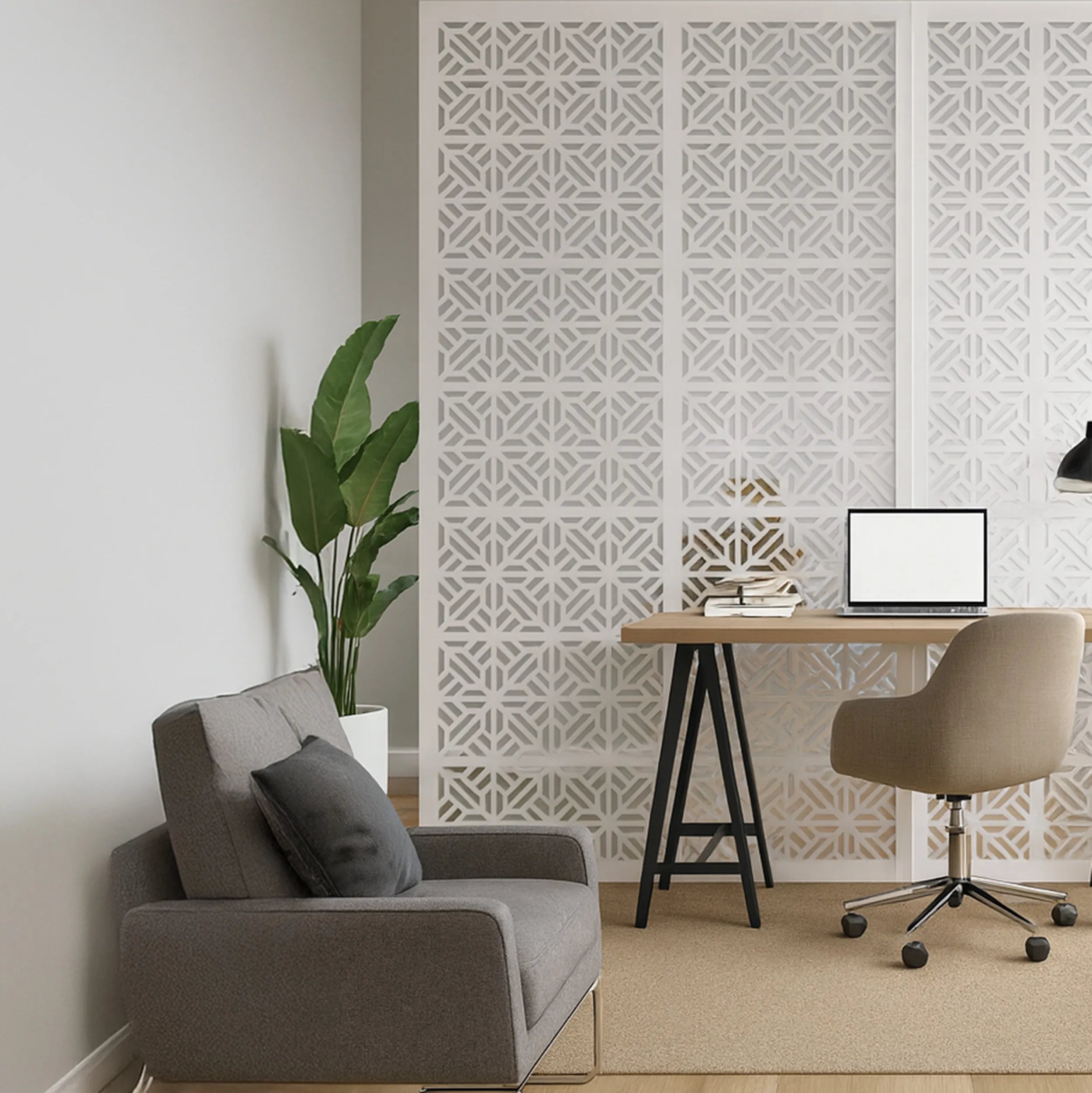 Modern home office with a gray sofa, desk, and decorative wall panel.