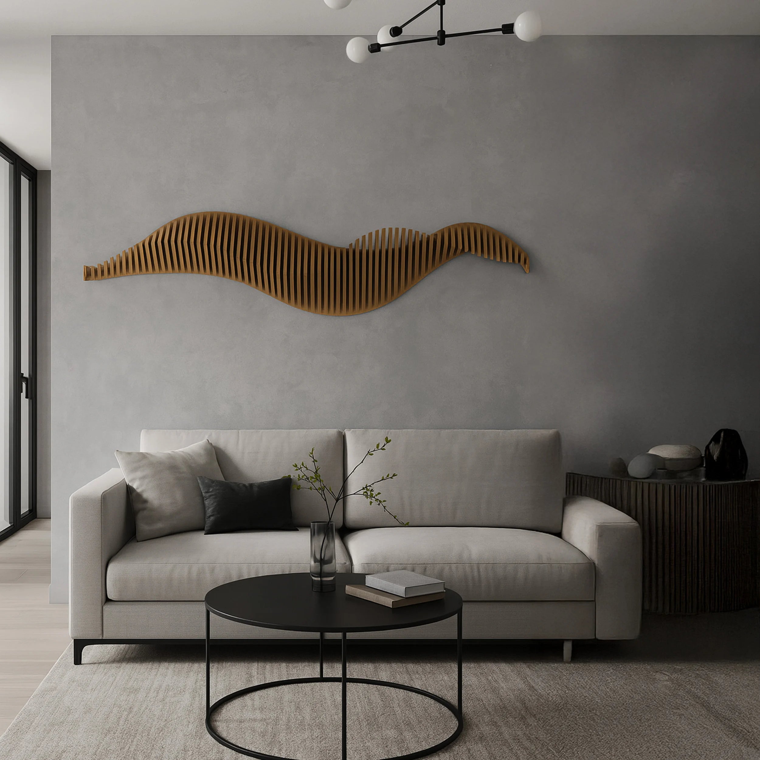 Modern living room with a gray sofa, round black coffee table, and decorative wall art.