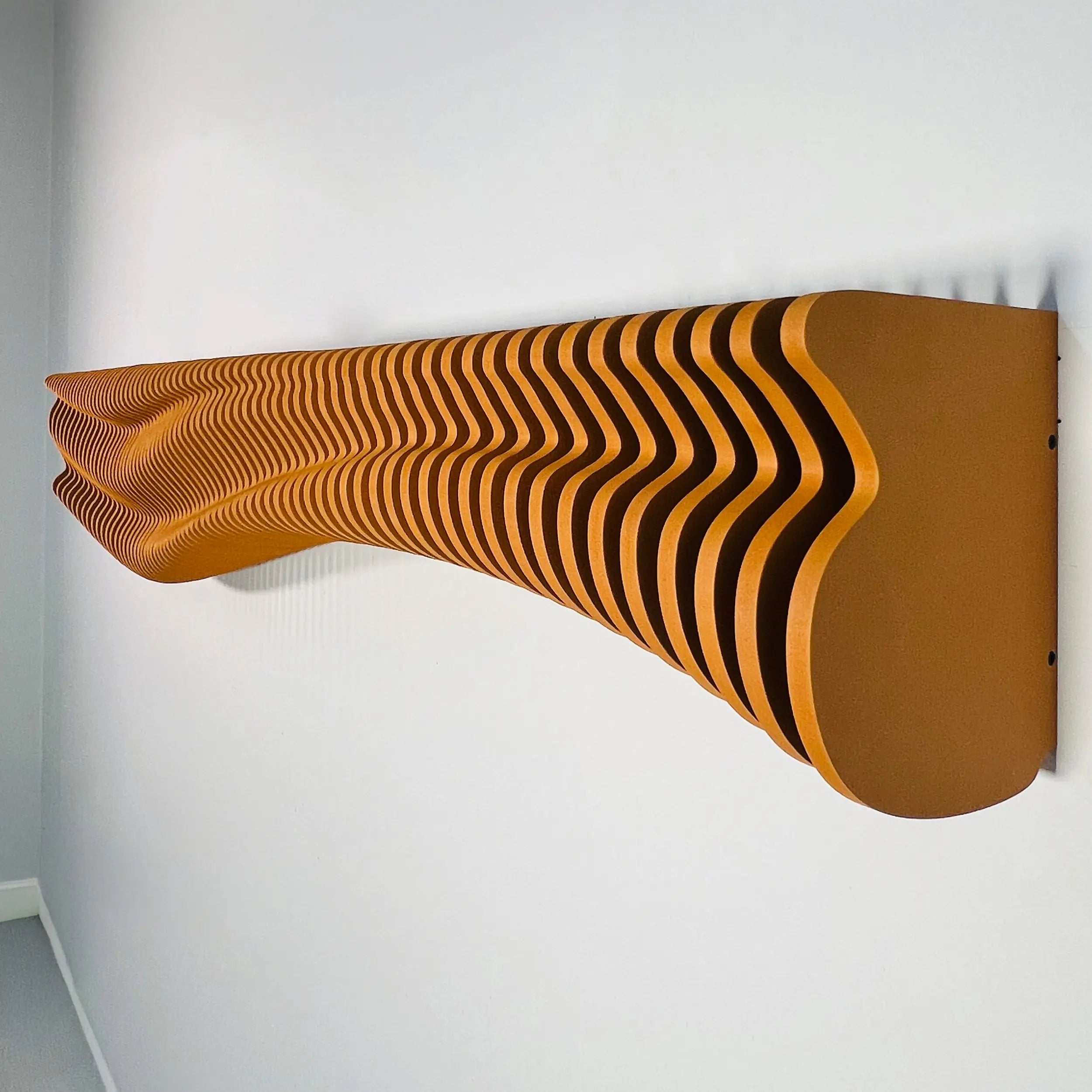 Wavy wooden shelf with black stripes on a white wall