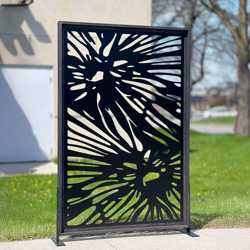 Decorative metal screen with abstract design in a garden setting