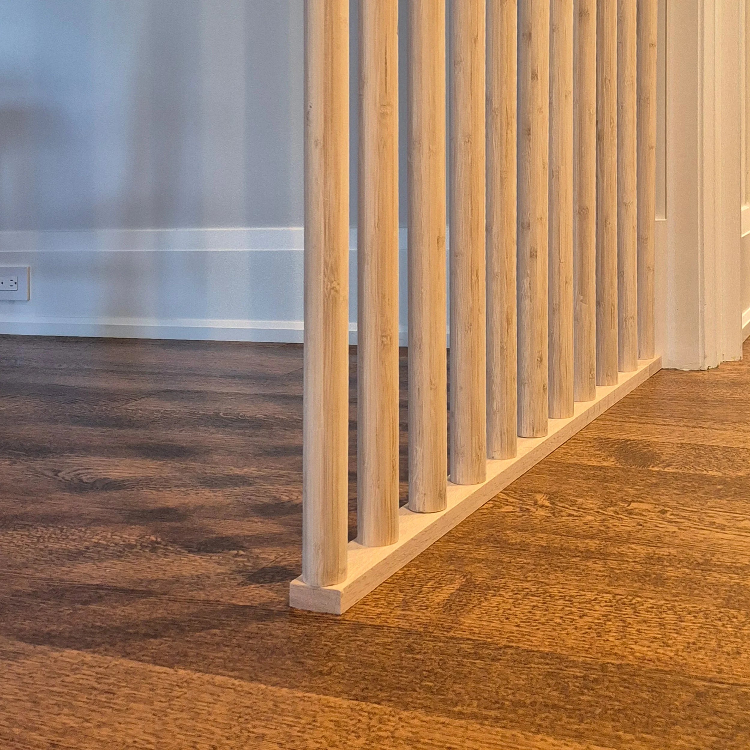 Wooden floor border with a wooden wall panel in a room.