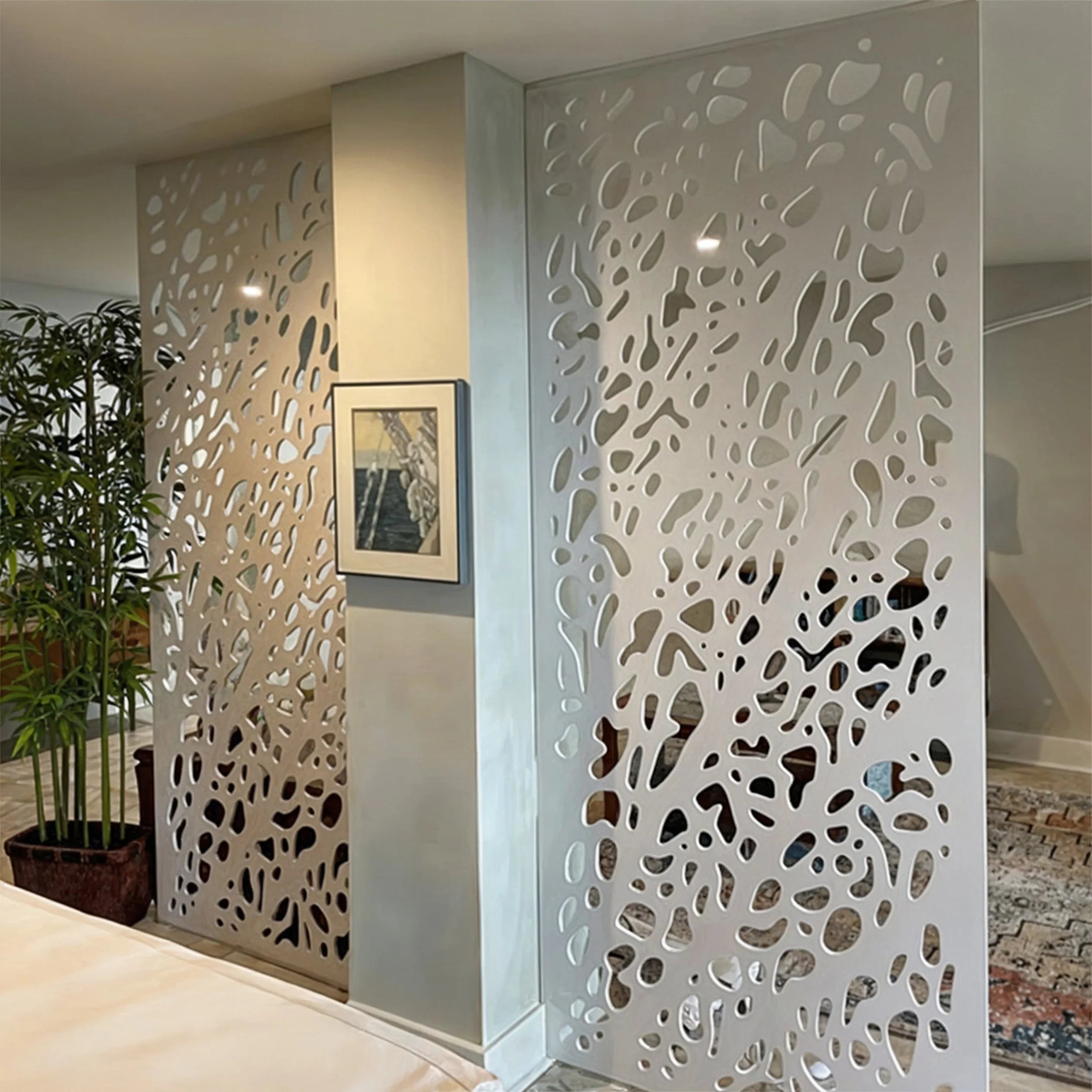 Decorative wall panel with cut-out patterns in a modern interior setting.