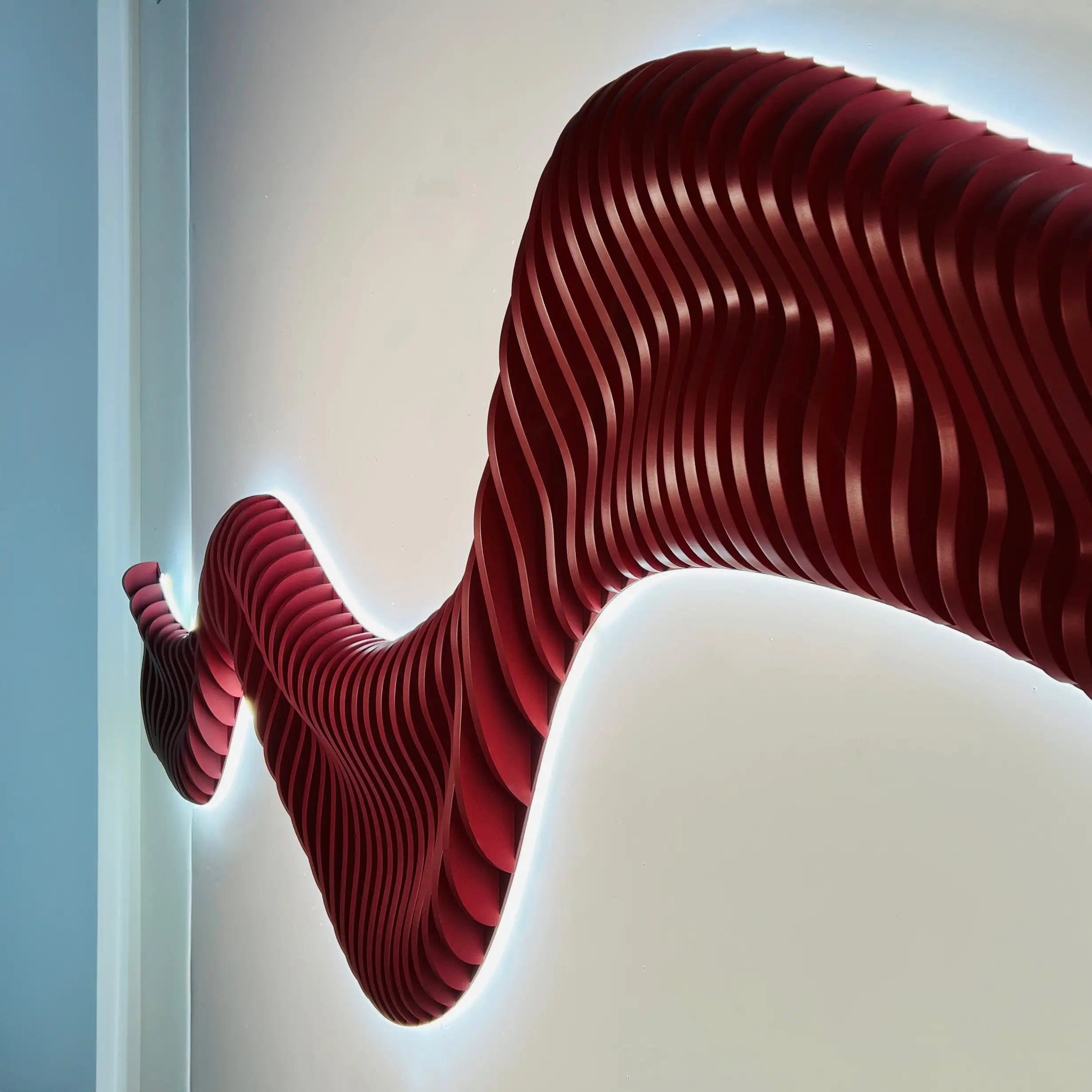 Red wavy wall art installation on a white wall