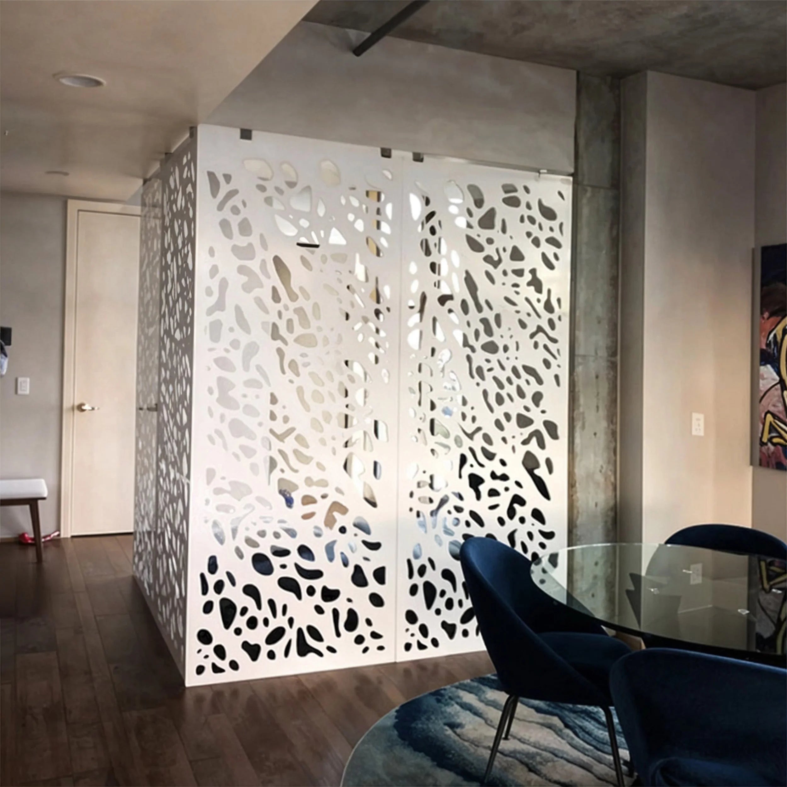 Modern interior with decorative wall panel and glass table