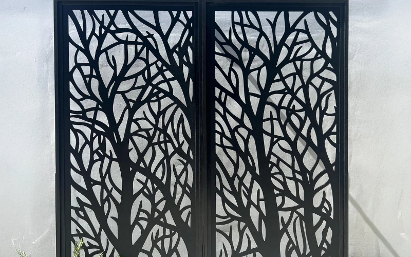 Decorative metal screen with tree pattern on a white background