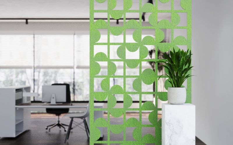 Green decorative screen in an office setting with a desk and chair.