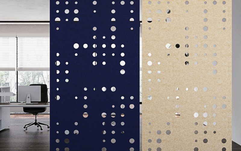 Two wall panels with a dot pattern, one blue and one beige, in an office setting.