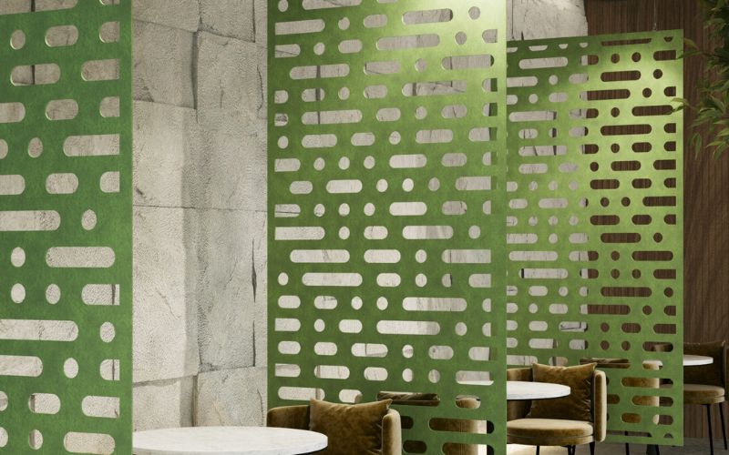 Decorative green screen with geometric pattern in a room setting