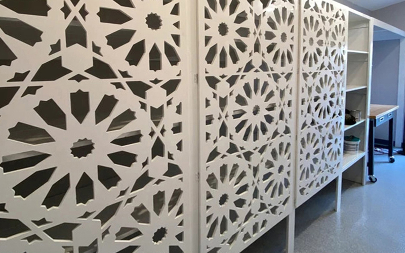 Decorative wall panels with geometric patterns in a room setting.