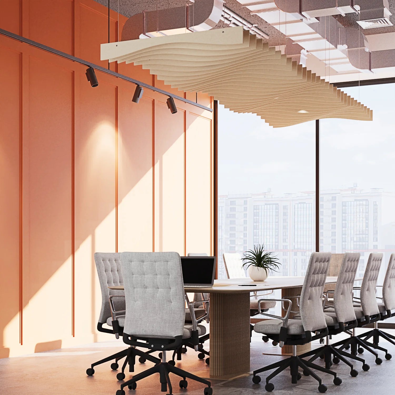 Modern conference room with a long table and gray chairs near large windows.