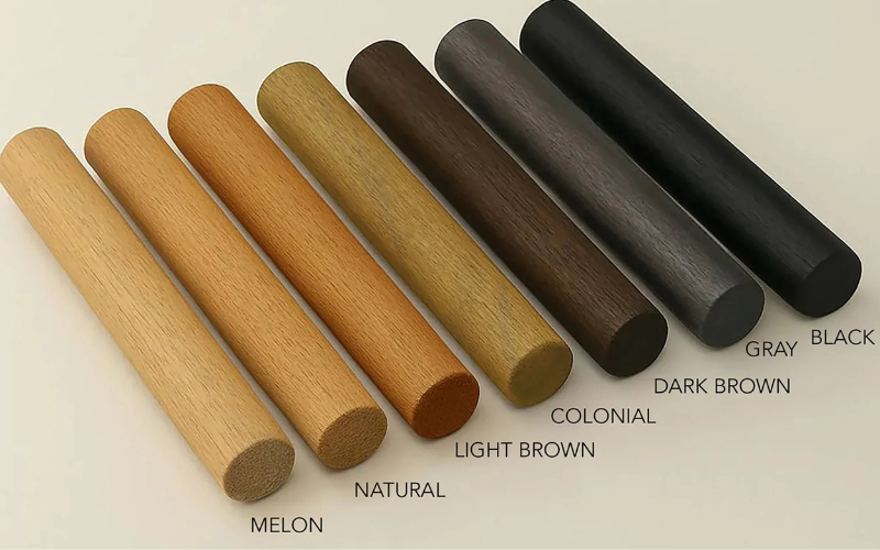 Set of wooden dowels in various colors on a beige background