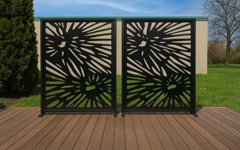 Decorative metal screen with geometric pattern on a wooden deck