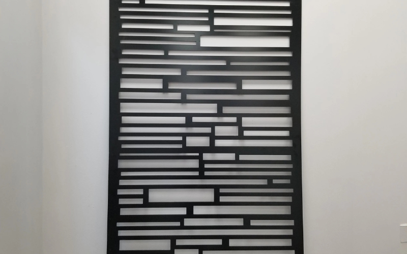 Decorative wall panel with geometric pattern on a plain background