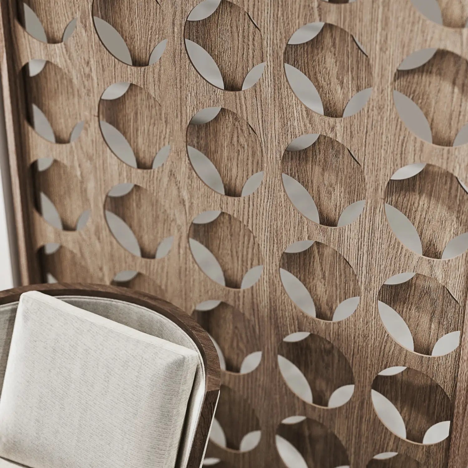 Wooden panel with leaf pattern and a folded white cloth on a chair.