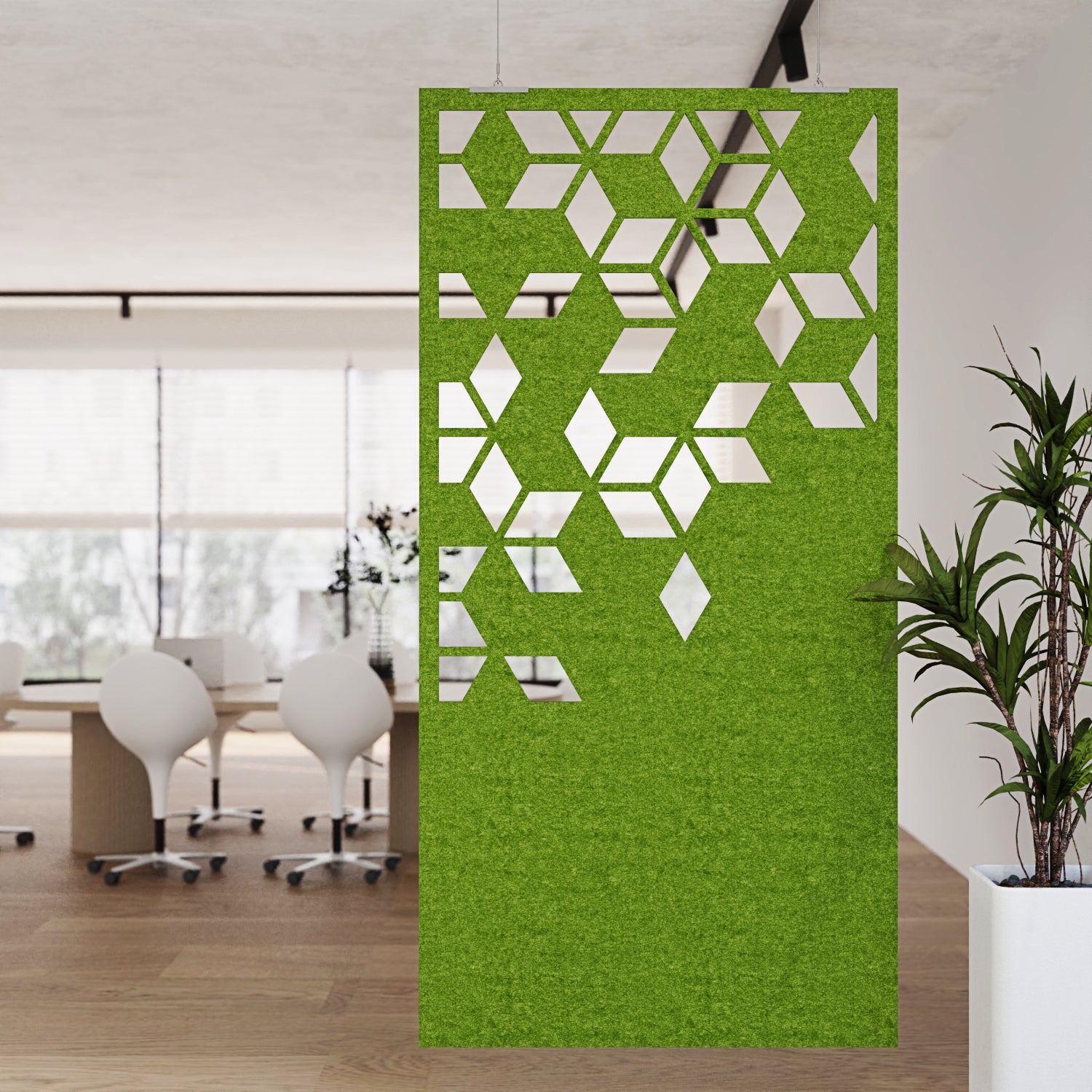 Green decorative screen with geometric pattern in an office setting