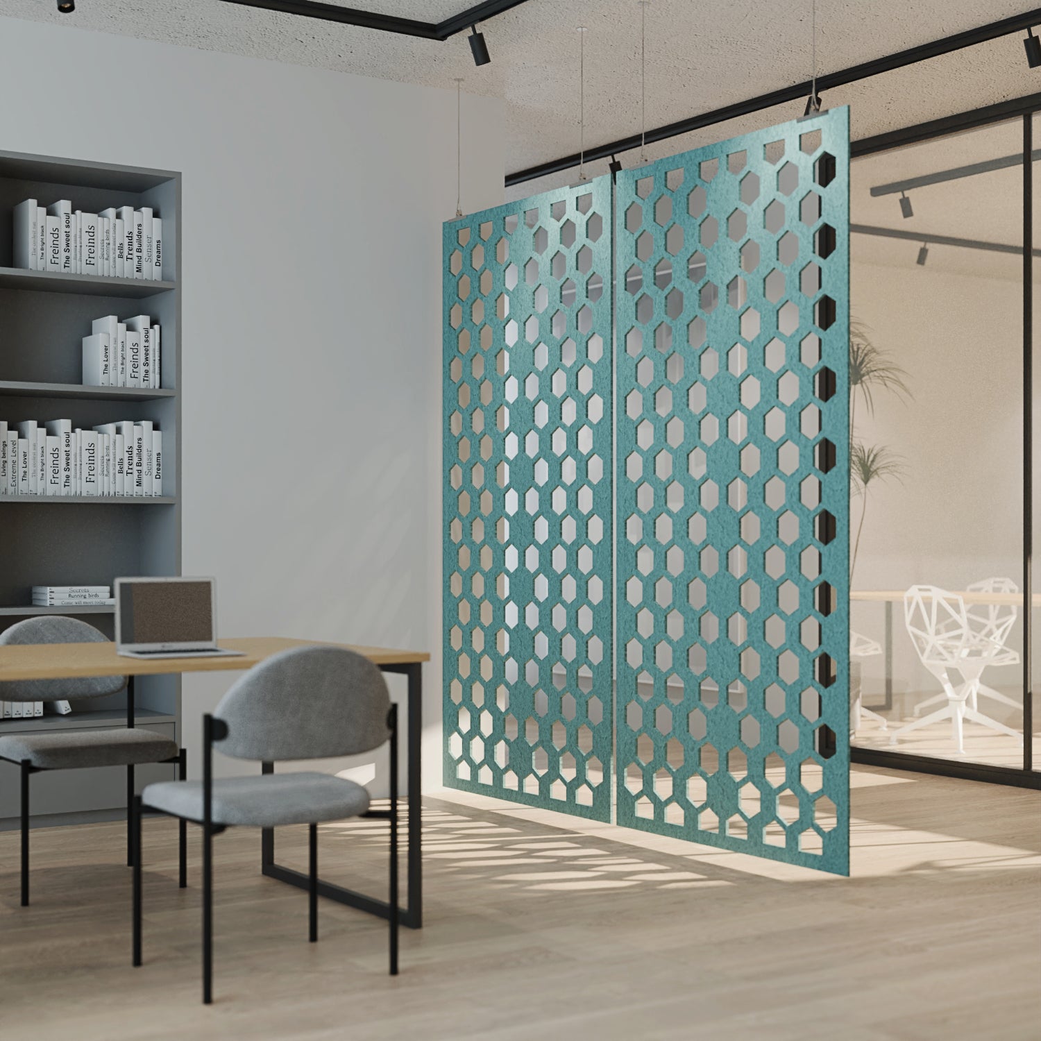 Modern office space with a teal perforated screen partition.