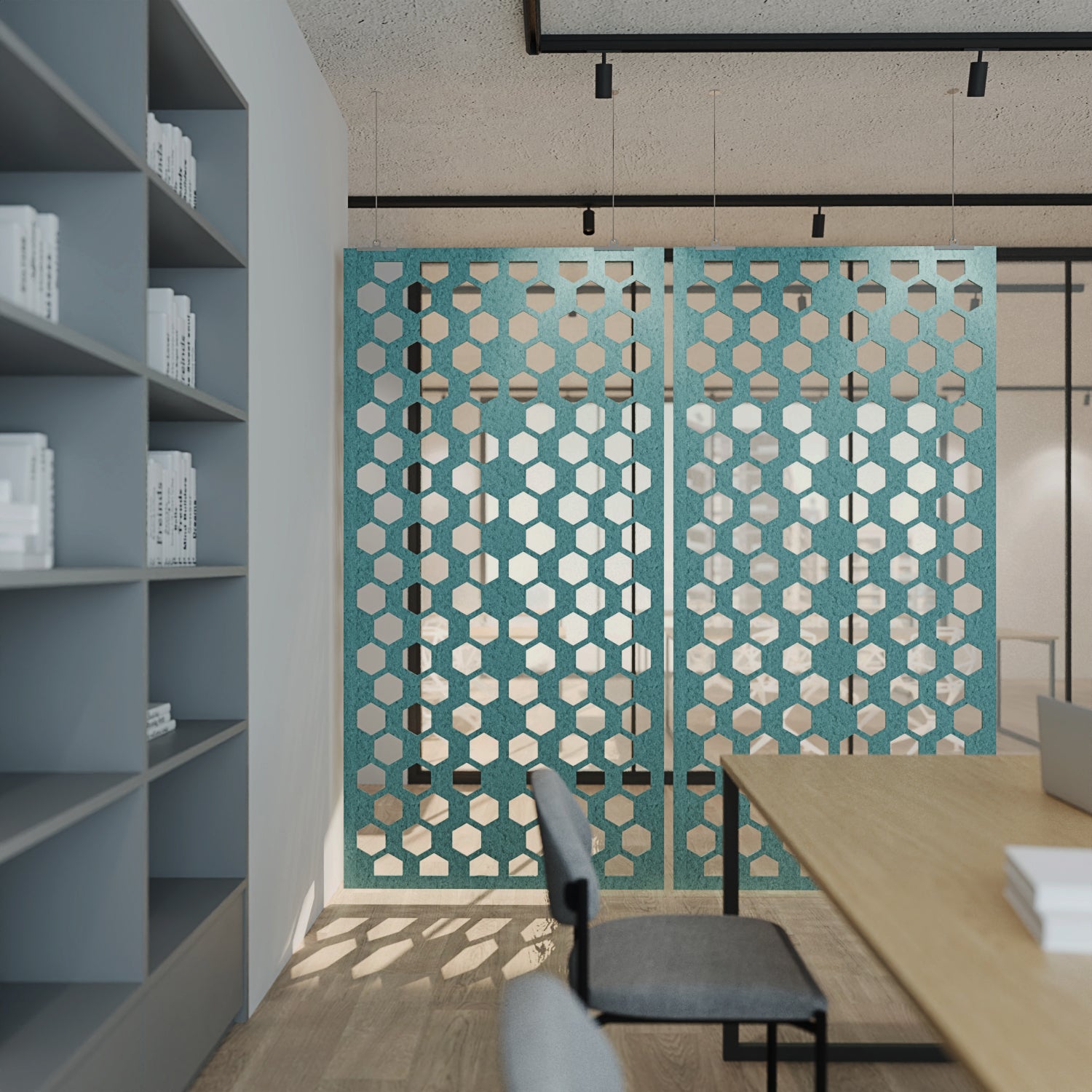 Modern office space with geometric wall design, bookshelves, and a desk.