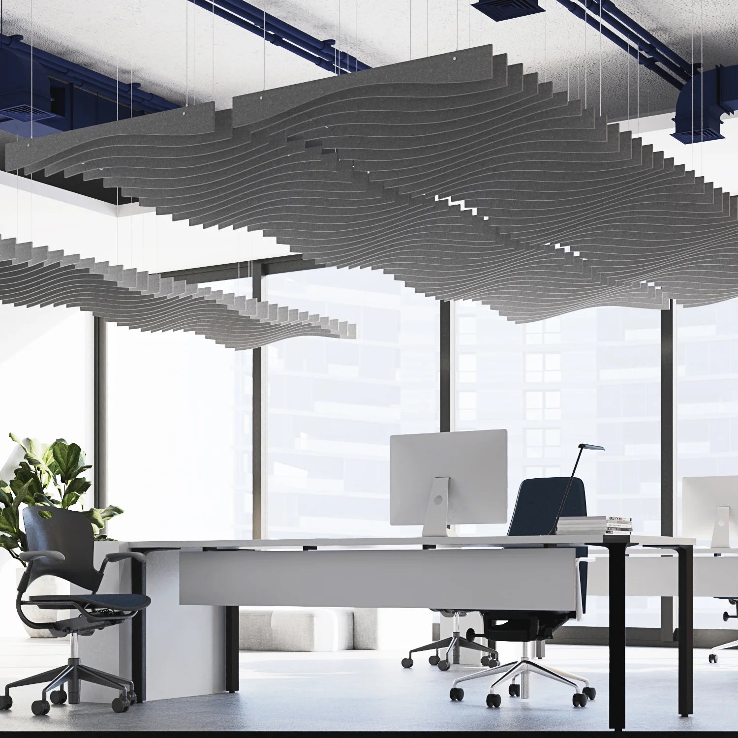 Modern office space with a large desk, chairs, and large windows.