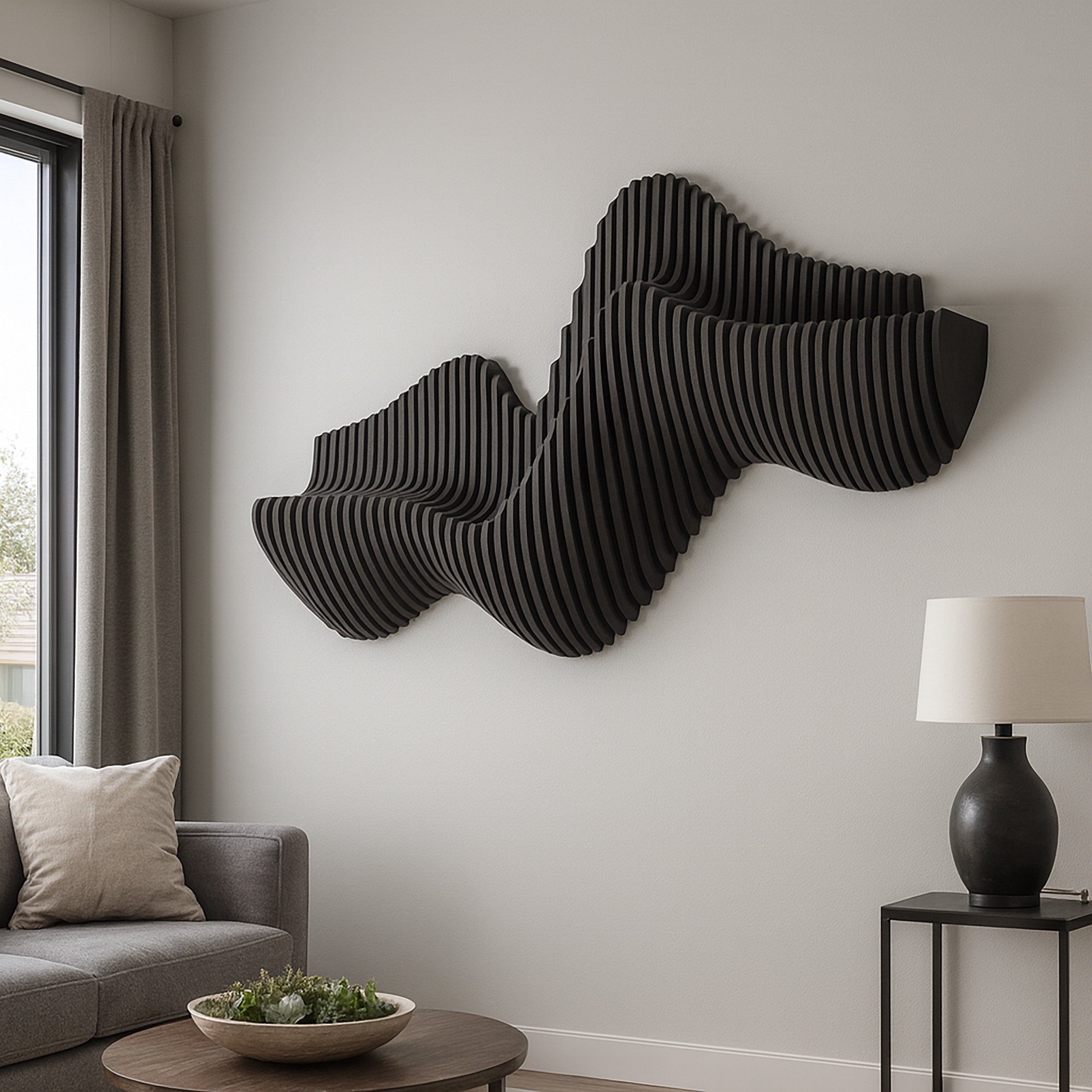 Modern living room with a black abstract wall sculpture, gray sofa, and side table with lamp.