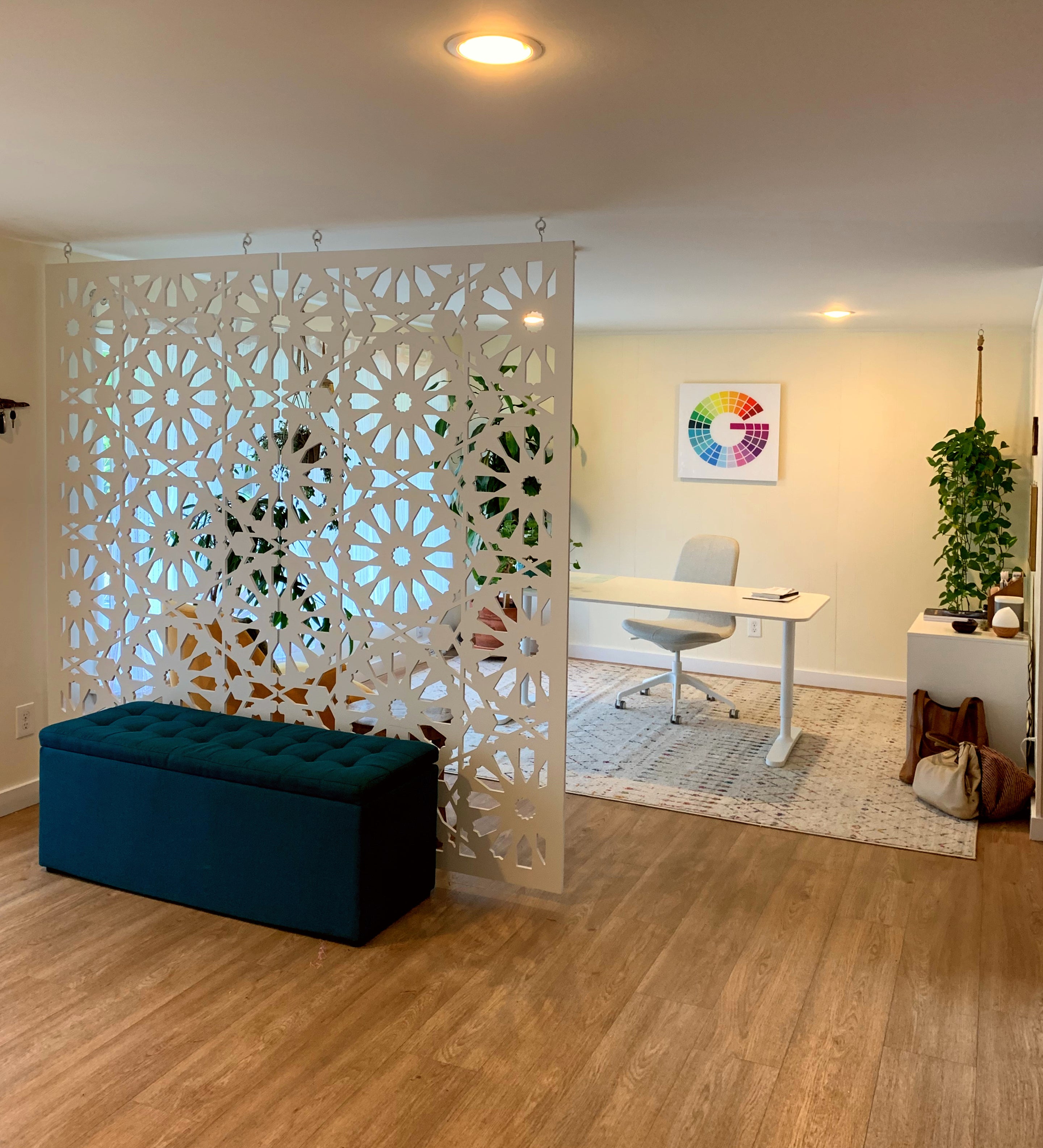 Decorative room divider in a home office setting with a desk and chair.