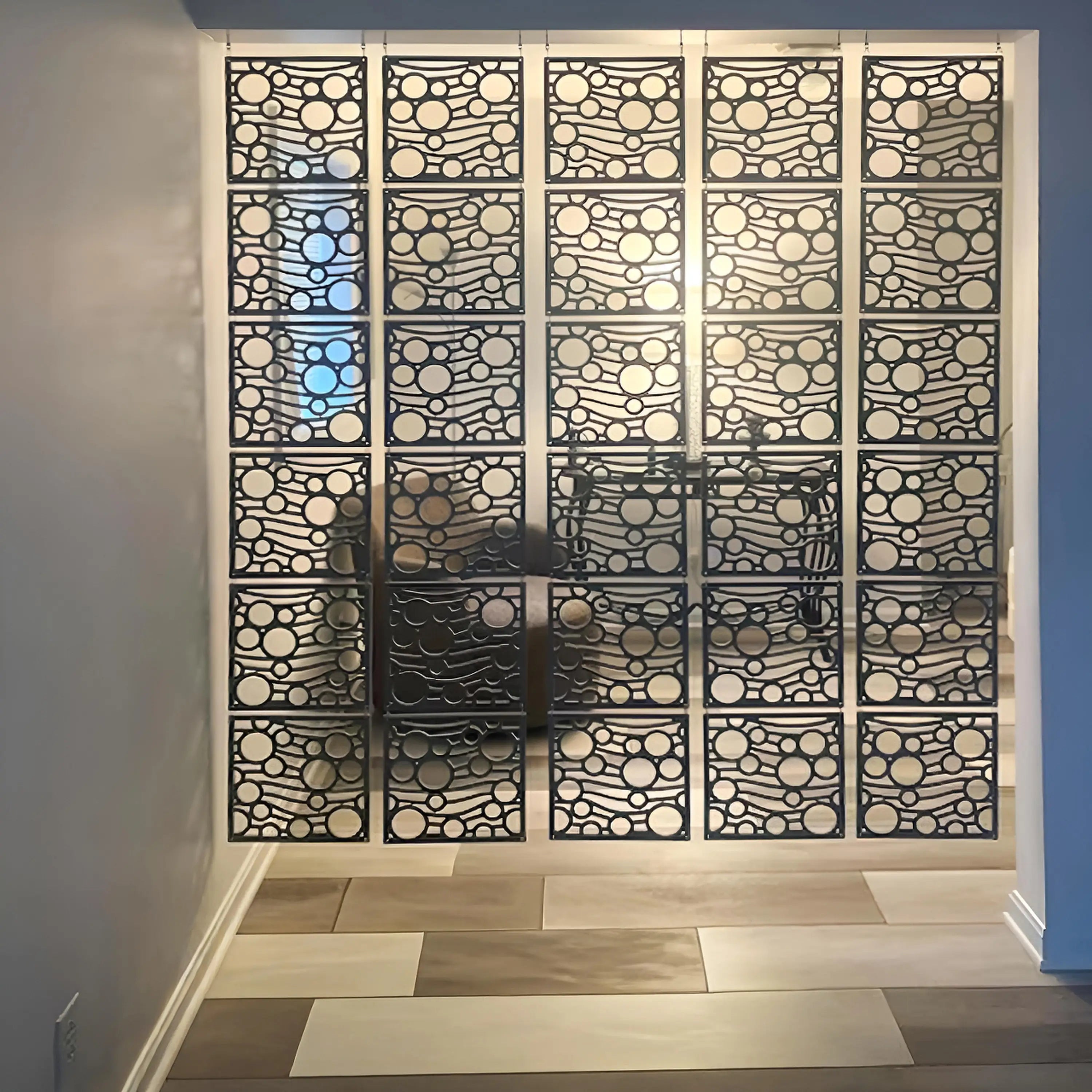 Decorative metal screen with circular patterns in a room setting