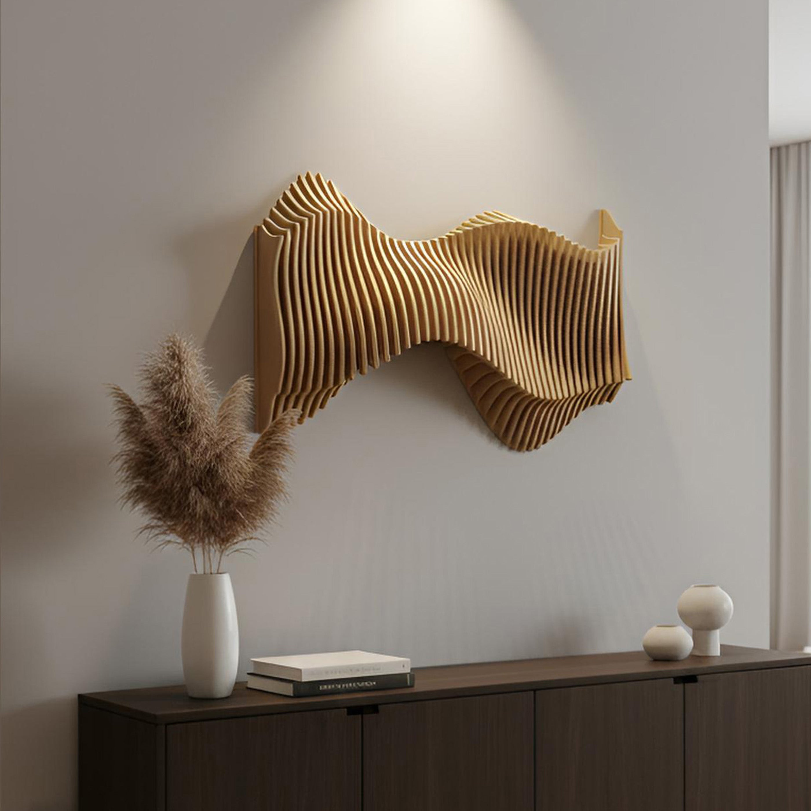 Wall-mounted decorative piece with a wavy design above a wooden cabinet with decorative items.