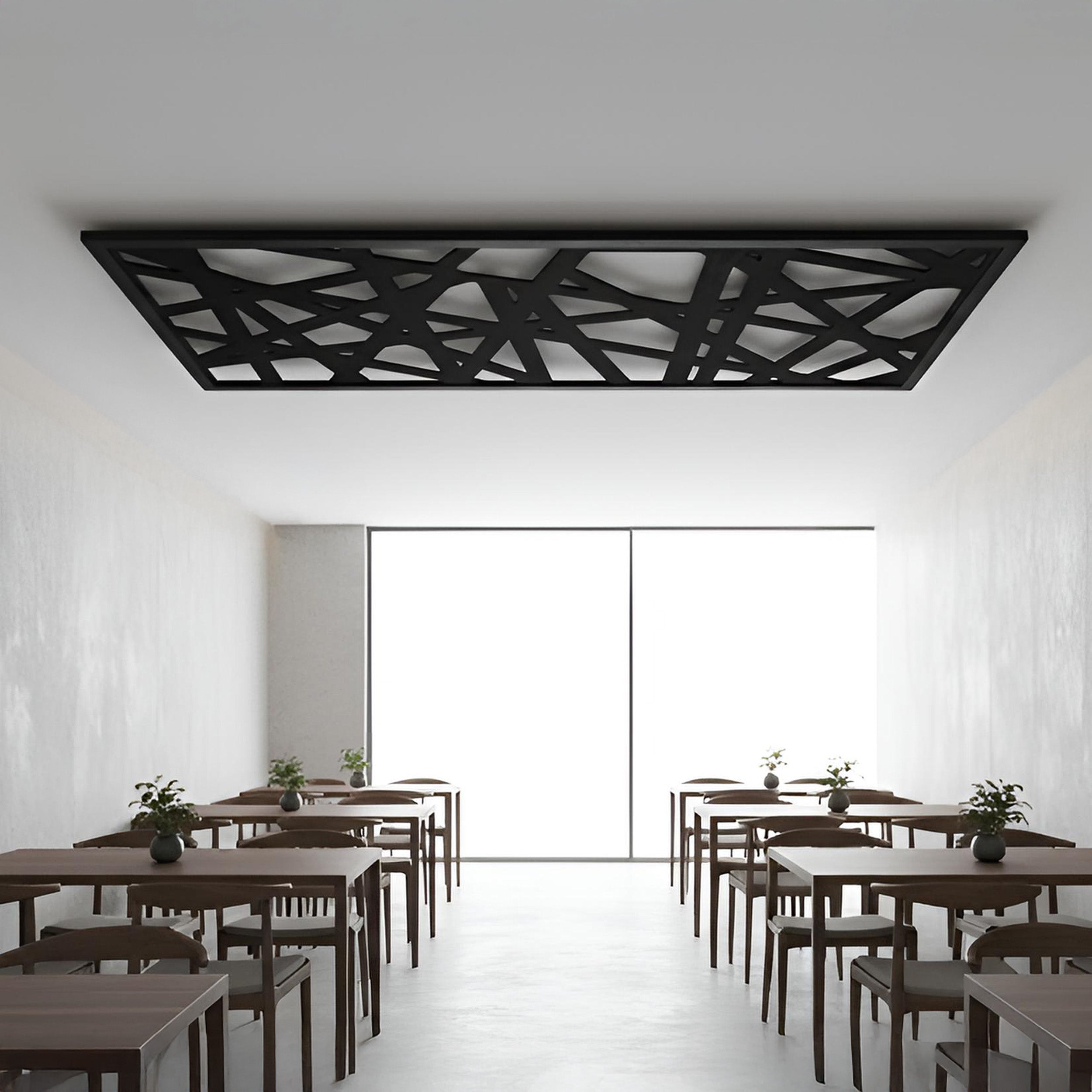 Modern classroom with wooden tables and chairs, white walls, and a decorative black ceiling panel.