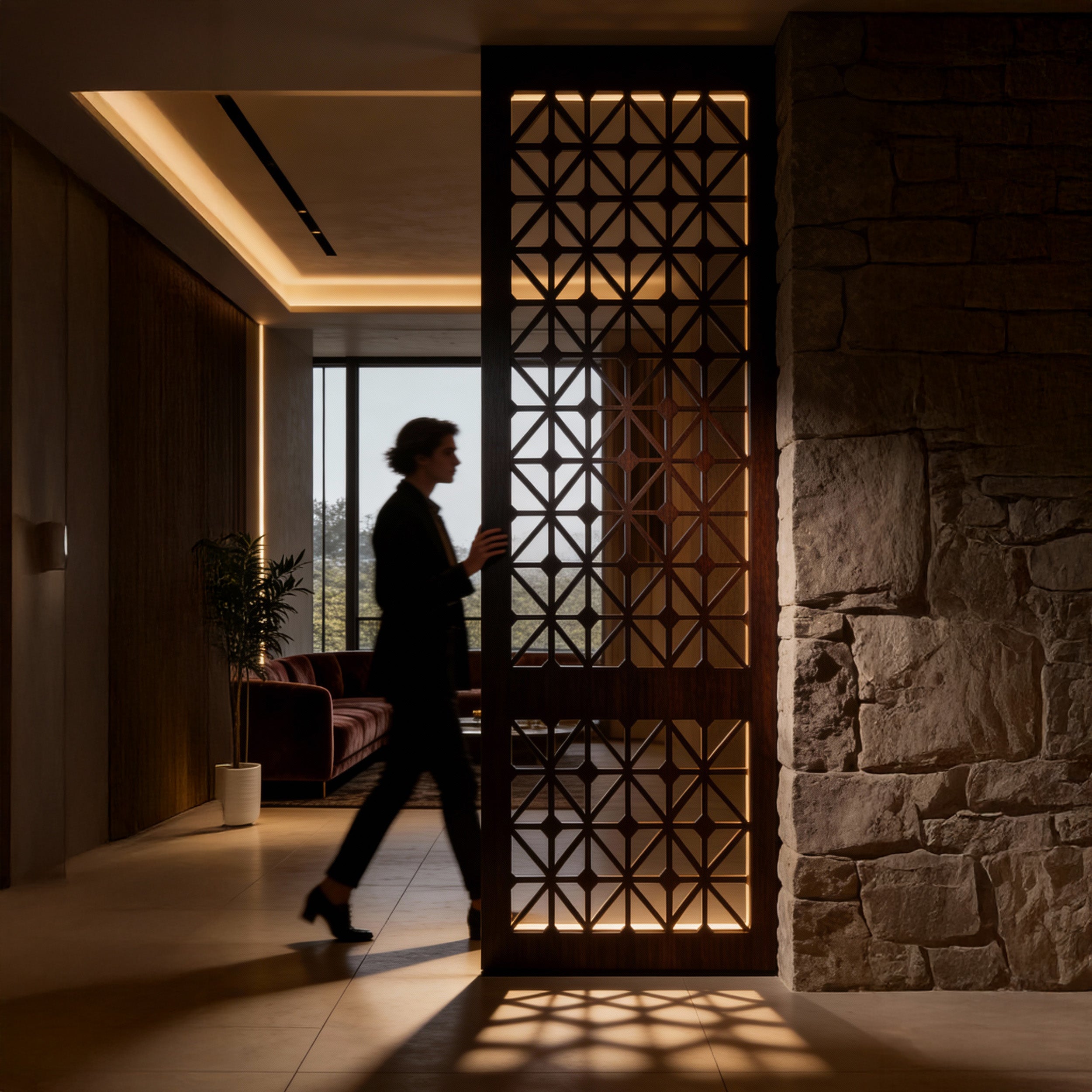 Person walking through a modern interior with geometric wall design and stone wall.