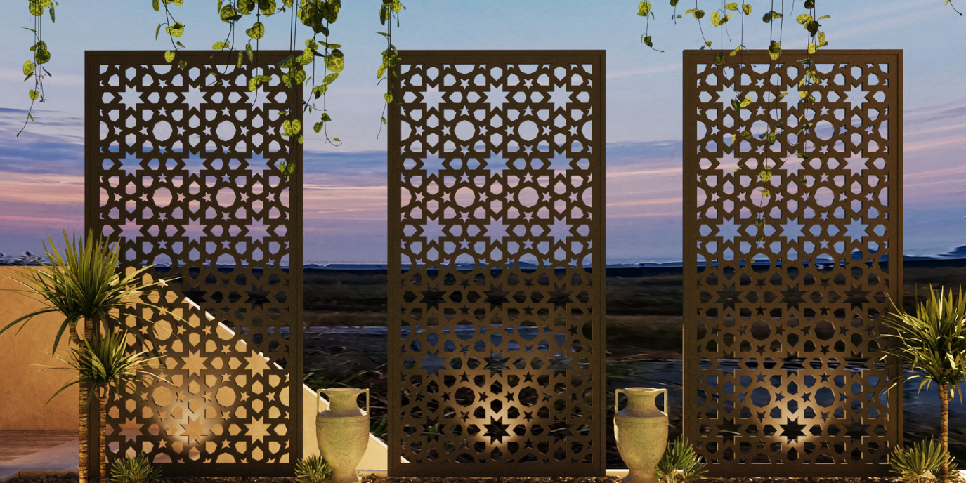 Decorative metal screens with intricate patterns in an outdoor setting at dusk.