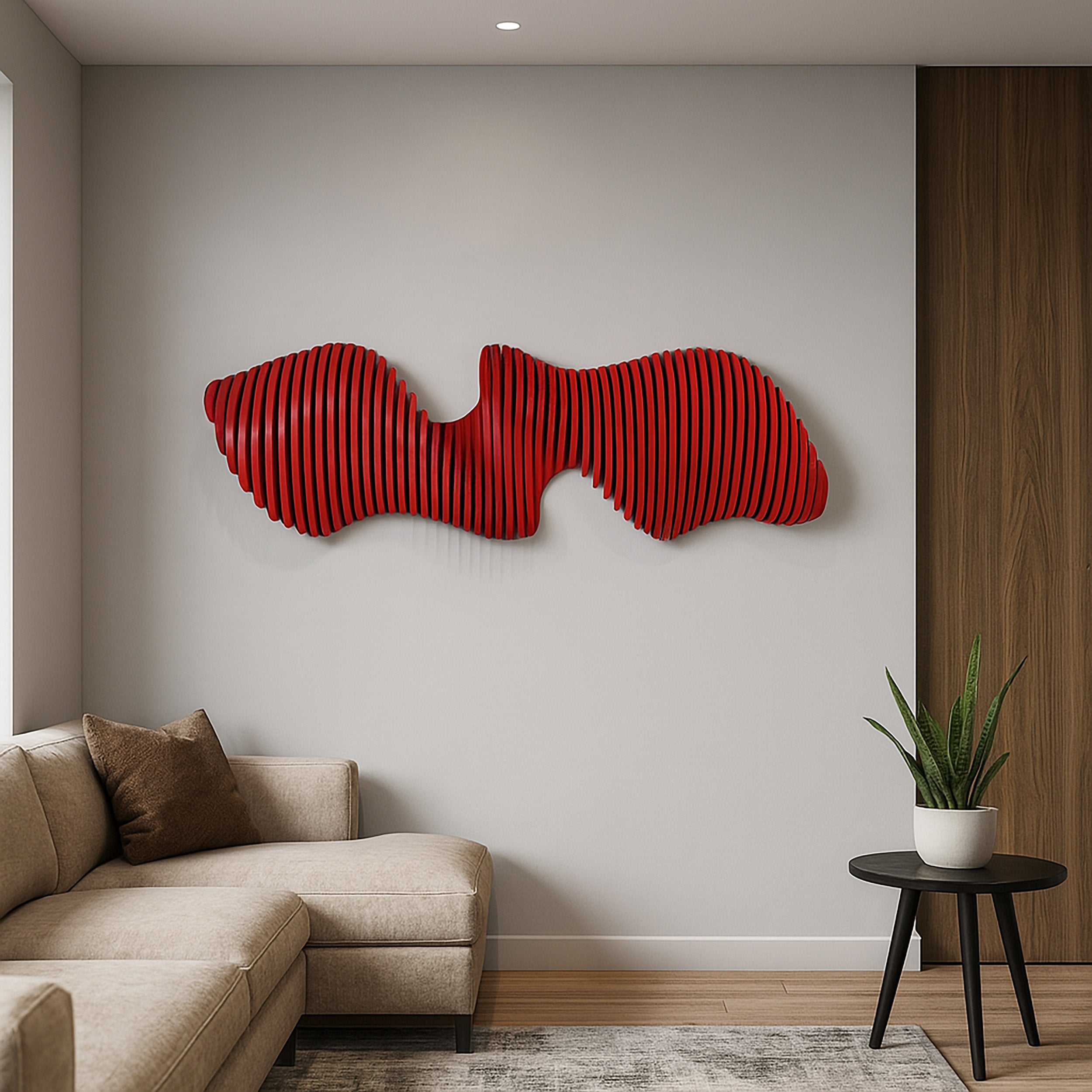 Modern living room with a red abstract wall sculpture, beige sofa, and small table with a plant.