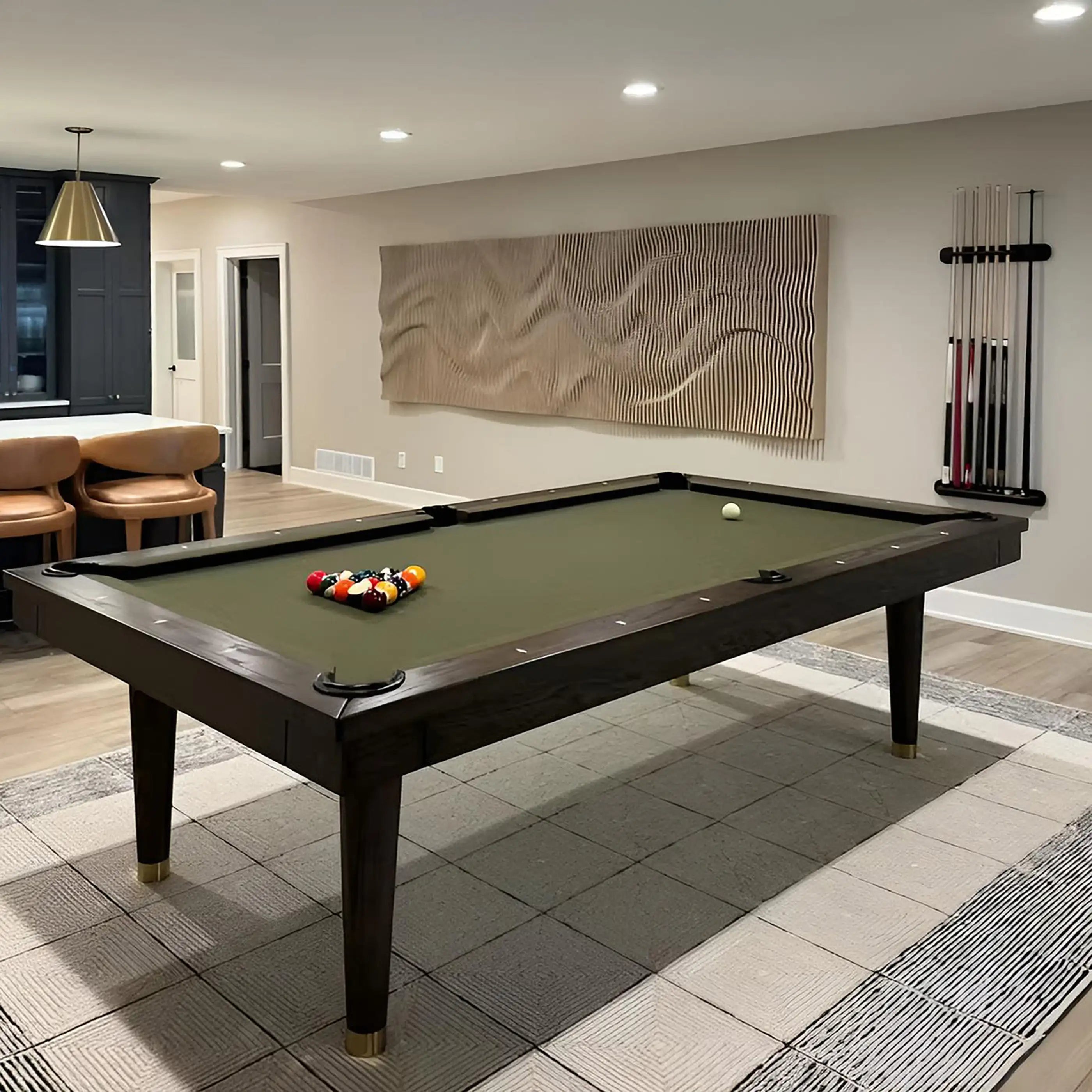 Pool table in a room with a decorative painting on the wall.