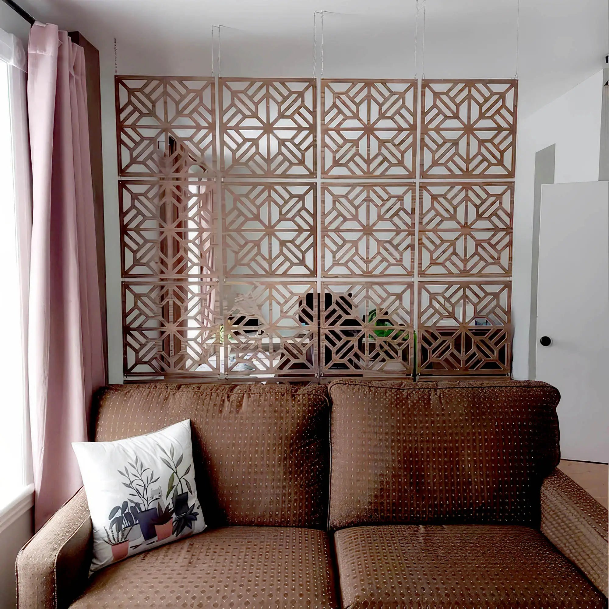 Brown woven sofa with a decorative pillow in a room with geometric wall art.