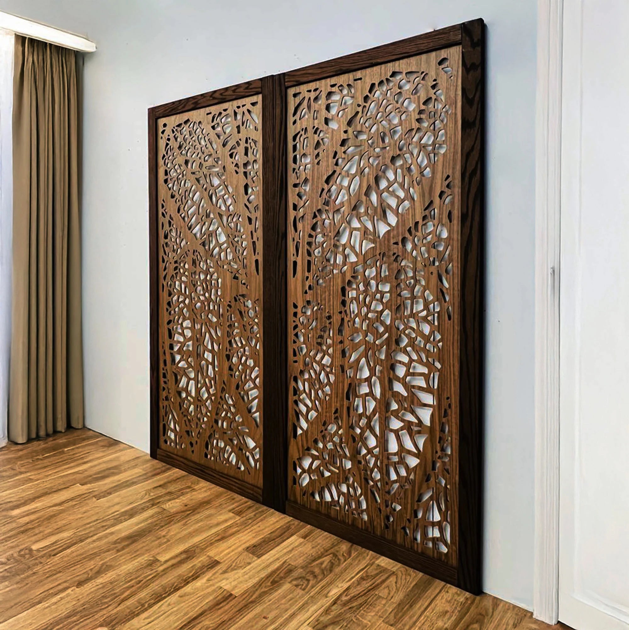 Wooden decorative panels with intricate cut-out patterns on a wall.
