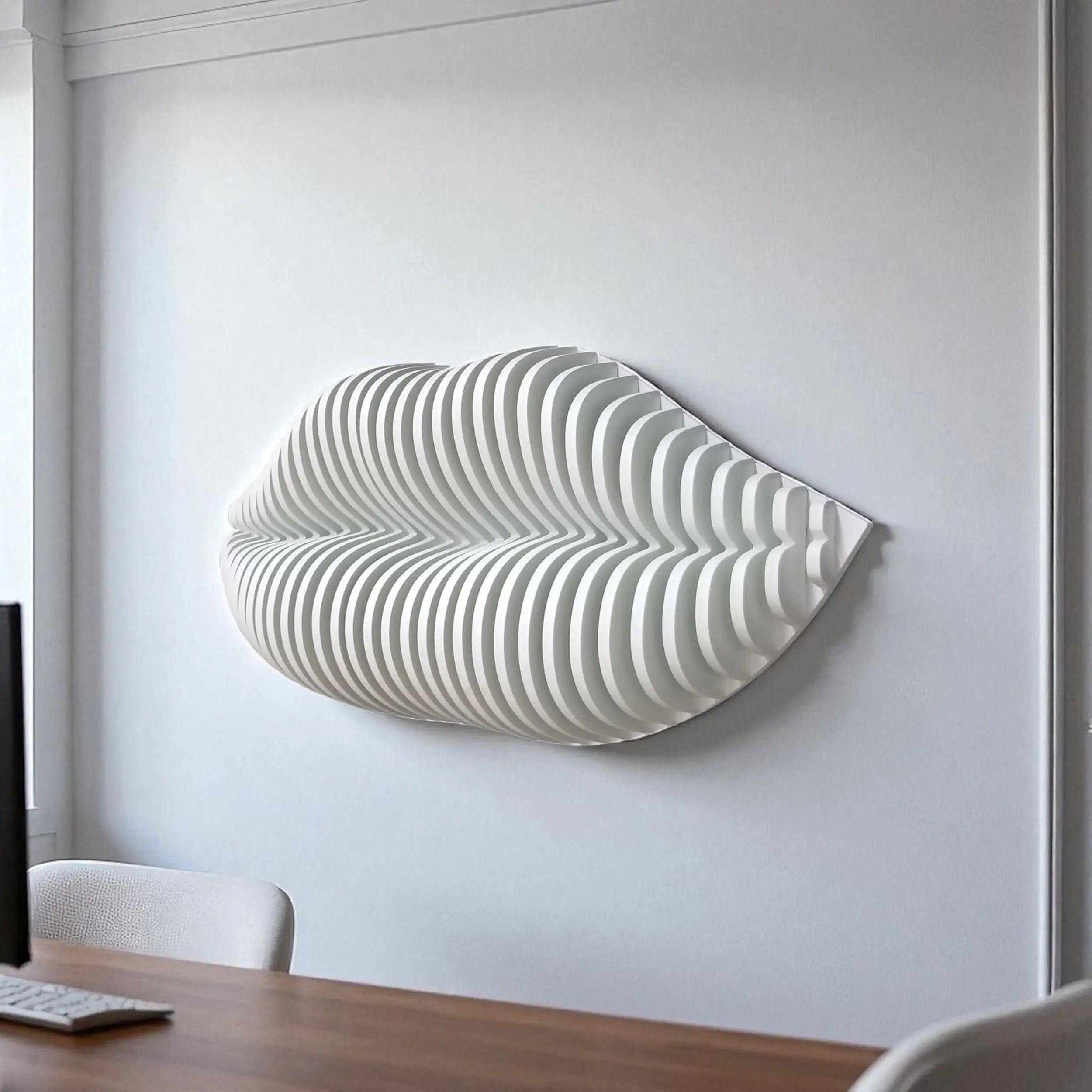 Modern wall art piece with wavy design on a white wall above a desk.