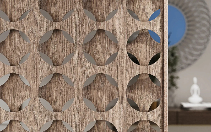 Wooden panel with geometric cutout design in a room setting