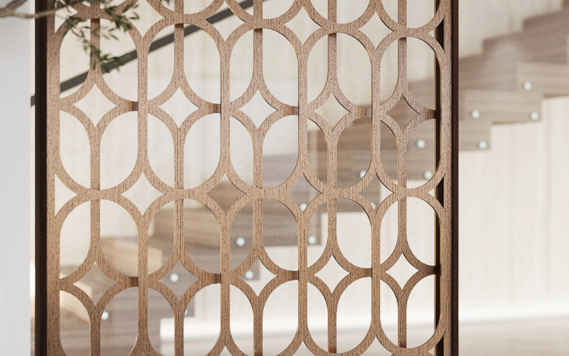 Decorative metal screen with geometric pattern in a blurred indoor setting