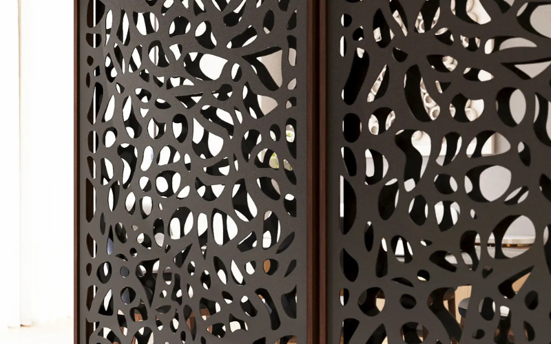 Decorative metal screen with intricate cut-out pattern